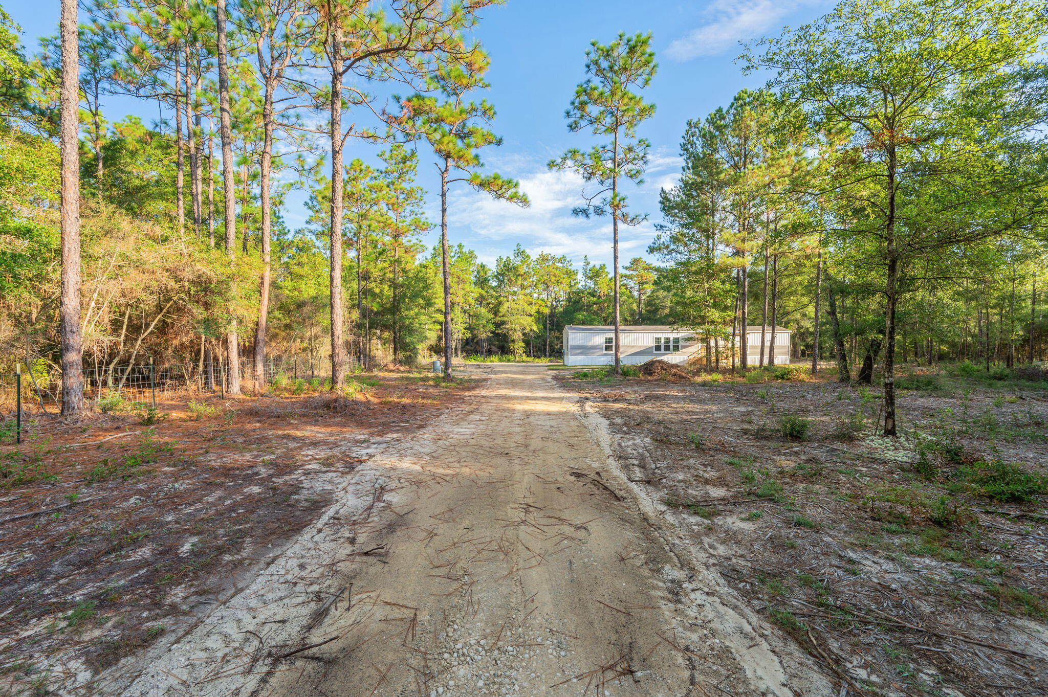 Escape the noise and discover your own private retreat. Be the first to live in this 3-bedroom, 2-bath home set on 2 fully fenced acres, offering rare space and serenity. Whether you dream of cultivating a garden, raising chickens, or simply enjoying open land without neighbors right on top of you, this property invites you to live closer to nature. The covered front deck is the perfect place to start and end your day in peace.

Inside, the home features a desirable split floor plan that provides both privacy and functionality. With no carpet throughout, you'll enjoy a clean look that is also easy to maintain. The kitchen is equipped with stainless steel appliances, ample cabinetry, a beautiful backsplash and a convenient breakfast bar ideal for casual dining or entertaining. The spacious master suite offers comfort and practicality with his and hers closets for generous storage. The ensuite bathroom includes ample cabinet space, a walk-in shower, and a double vanity, creating a relaxing and well-designed retreat.