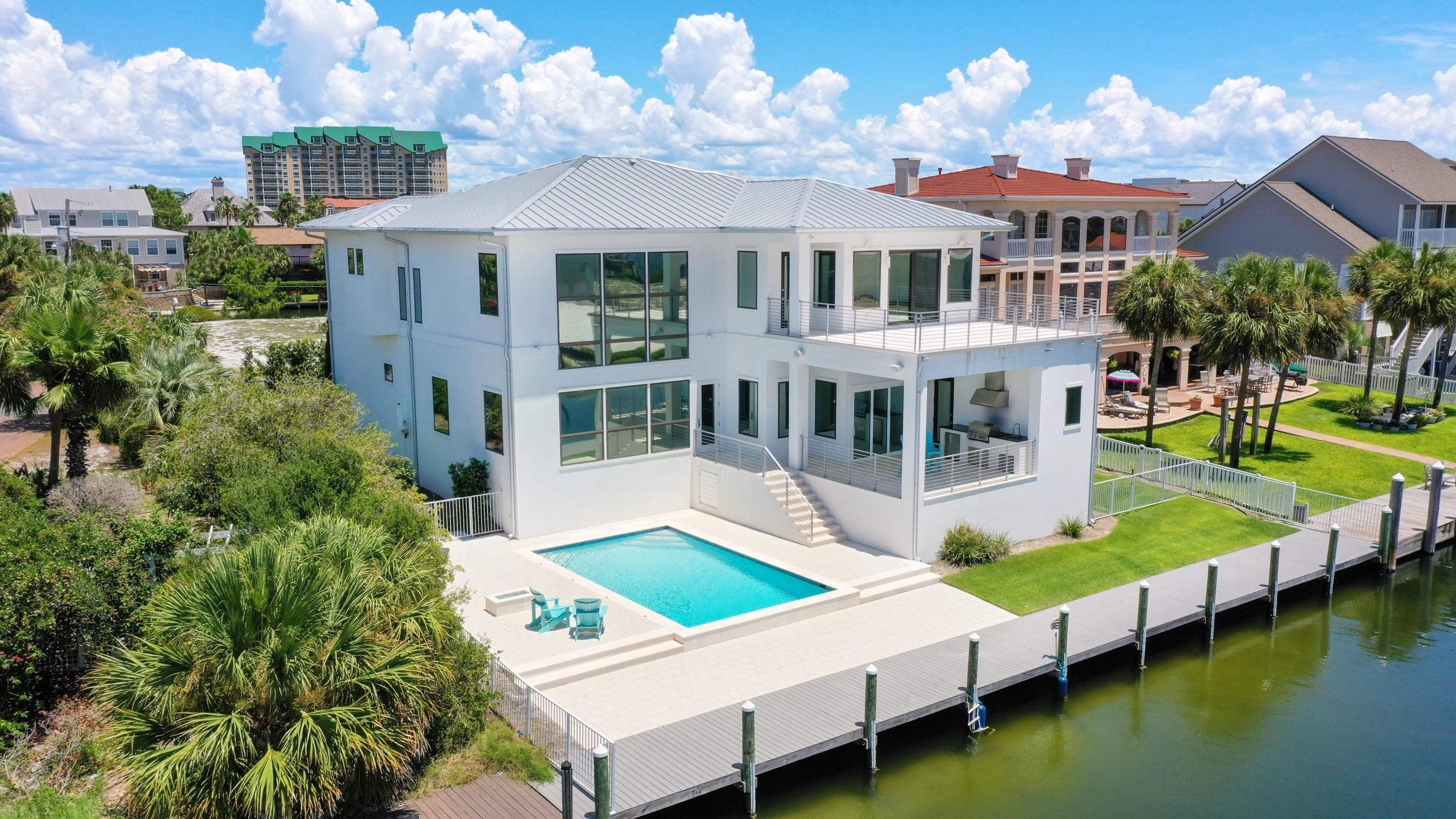 This stunning waterfront home is located on Holiday Isle in the heart of Destin. Done in a contemporary style you'll find neutral tones along with premium features including an incredible chef's kitchen, expansive windows, quartz countertops, polished concrete and hardwood flooring, a hidden pantry, and so much more. The summer kitchen, fabulous pool area, and 90 foot dock provide the ultimate in outdoor living. The master suite is incredibly spacious and glass sliders lead to the large second floor balcony. The master bath features a garden tub, separate shower with dual rainfall shower heads, and two walk-in closets. With multiple guest suites and additional rooms – this home is made to be enjoyed by many! You're just a walk or bike ride away from the beautiful beaches here in paradise!