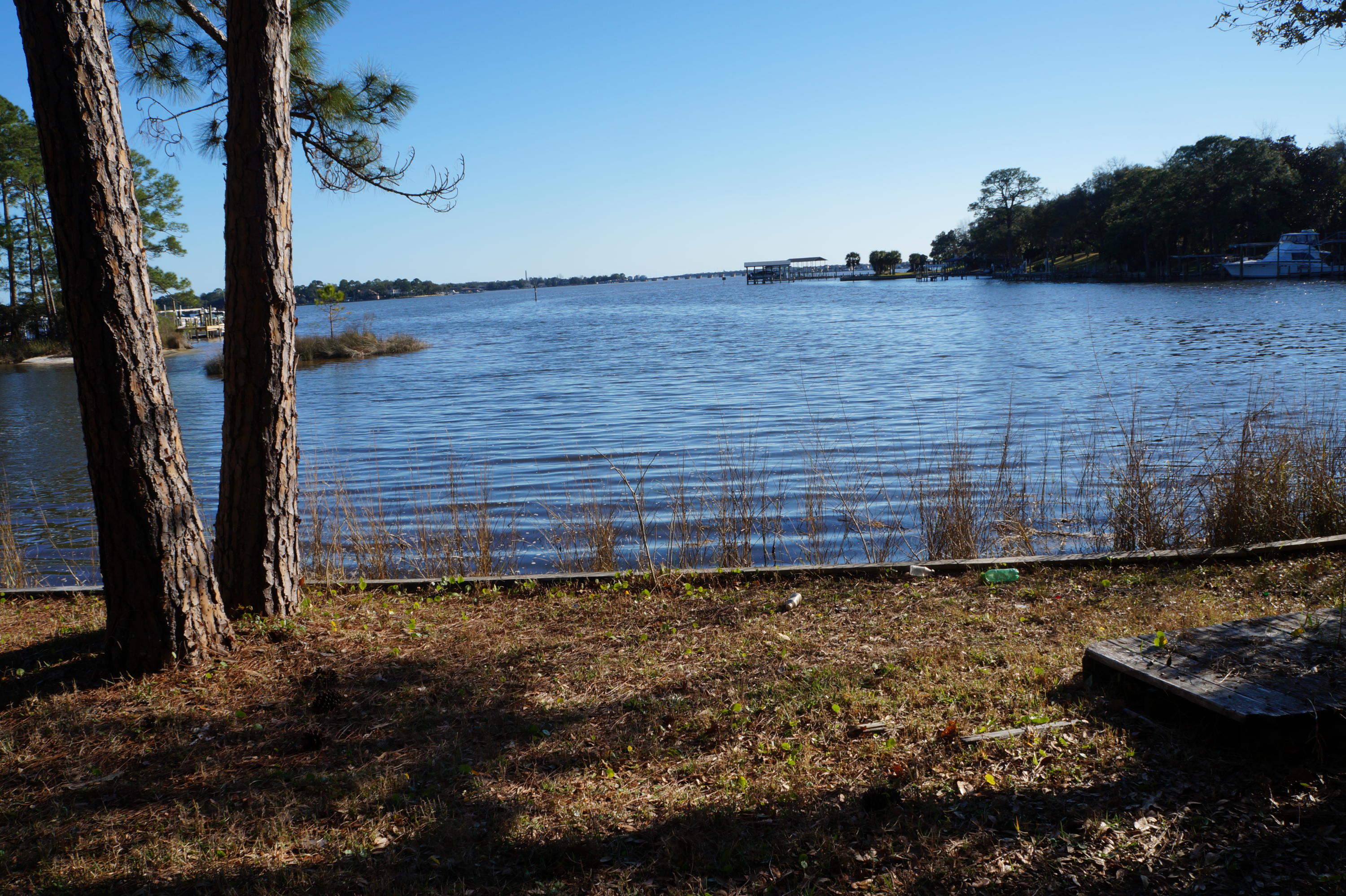 Rare opportunity in Poquito Bayou!! Simply beautiful .35 acre waterfront lot! Well maintained property with sweeping large oak trees. High and dry with 95' of waterfront offering spectacular views of Garnier's Bay and Hands Cove. Private entrance to Hands Cove with no through traffic. Right around the corner is the Poquito Park with a roped off swimming area, picnic area and boat ramp. Hands Cove is a perfect piece of paradise to boat, paddle board, canoe, swim or simply enjoy the views and dolphins!