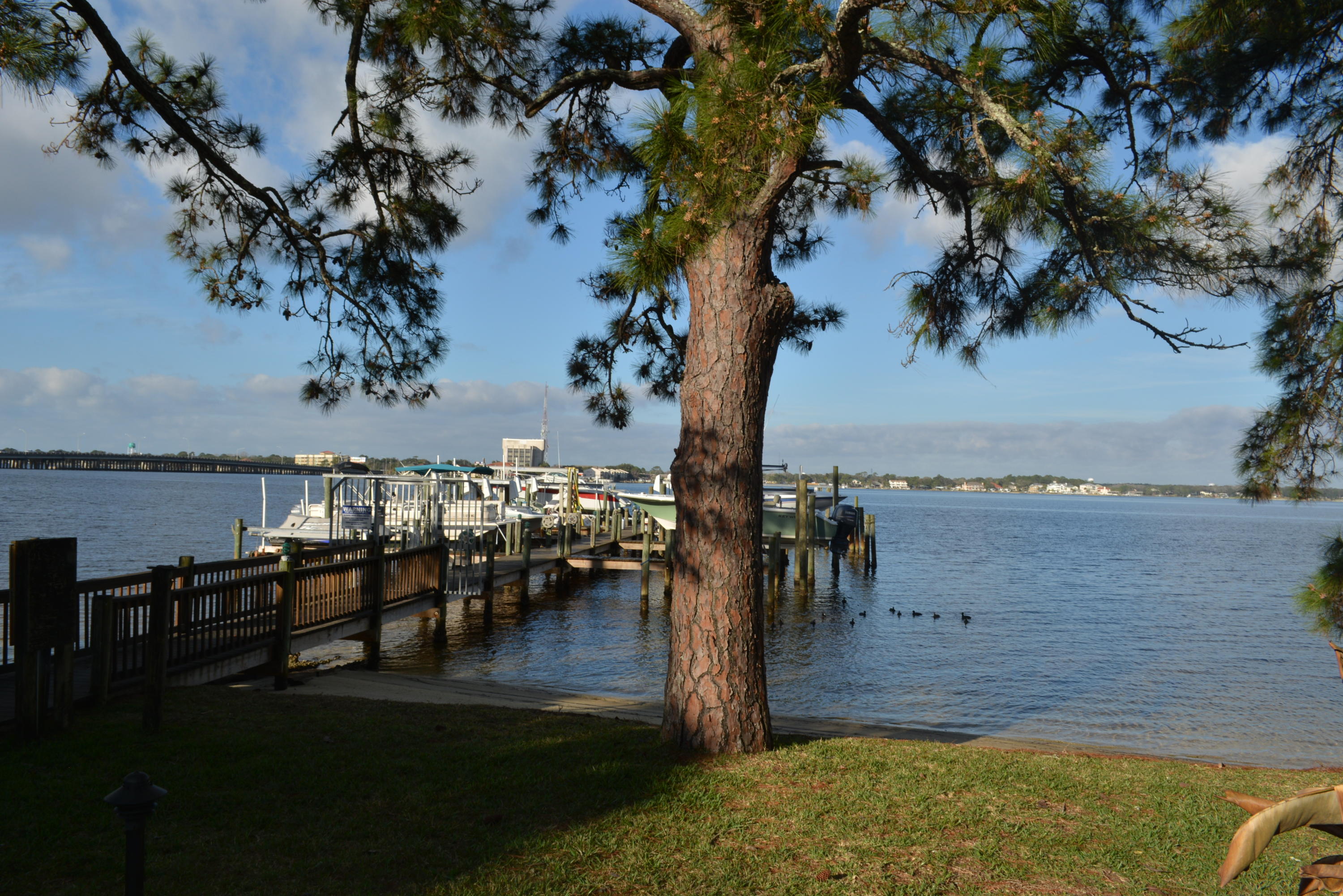 Desirable Waterfront Town Home that is located on the Bayou! Unit includes a Boat Slip! The rear view faces West, so you always have a sunset, always a breeze! Bottom Floor has views of the Bayou from Kitchen, Living Room and Dining Room! Kitchen has Granite Counters and Stainless Appliances. Tile throughout 1st Floor. Cozy fireplace in Living Room to keep warm on the cool nights in Fall and Winter. Large Deck to Enjoy the Spring and Summer months! There is also a 1/2 Bath on this floor. 2 Bedrooms each with their own private bath upstairs. Light at the end of the dock for night fishing, excellent crabing from the dock. Front trees are lighted at night. Shade from the large trees helps with the summer afternoon heat. This is a MUST SEE unit! Call for more information!