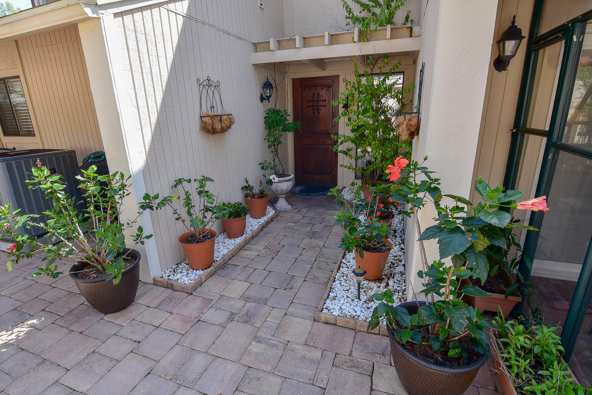 Beautiful ground floor master suite townhome! Boasting a spacious and inviting paver patio, , a greenhouse room and a Florida room, this three bedroom, three bath townhome combines indoor and outdoor areas for everyone. Large open great room with a soaring ceiling and a staircase leading to two bedrooms, a full bath and a loft area with plenty of usable space including a built in desk and storage. Updated kitchen with new appliances, new HVAC and 4 year old roof maintained by the HOA. This home is nestled in a quiet, serene development close to the tennis center and the rest of the fantastic amenities of Bluewater Bay. Carefree living and wonderful outdoor living space!