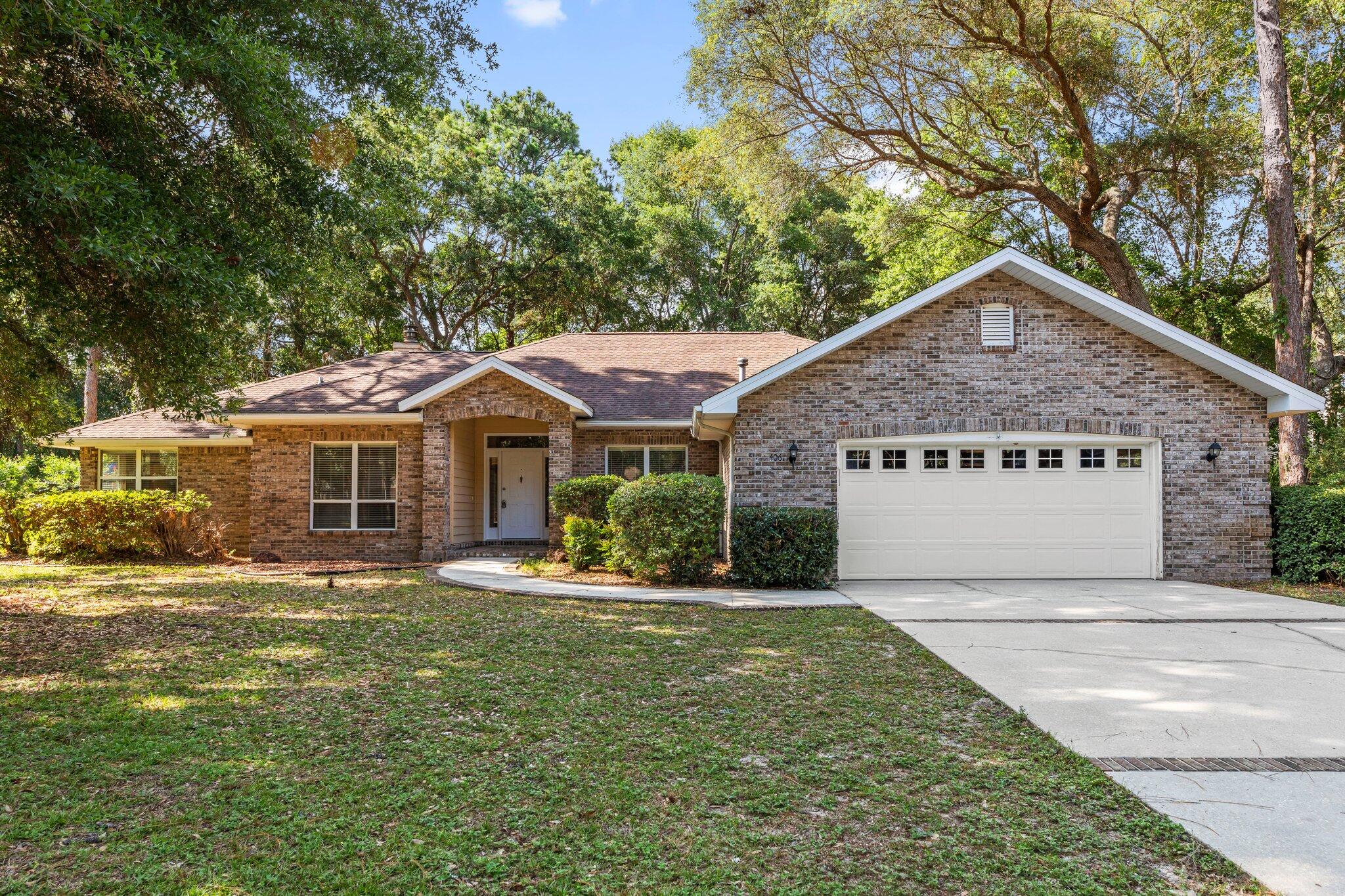 Nestled in the sought-after Rocky Bayou community, this inviting single-story brick home offers comfort, space, and timeless charm. Step through the welcoming entryway into a large formal dining room filled with natural light from a picture window. The cozy living area features vaulted ceilings and a warm fireplace with a classic wood mantle—perfect for relaxing or entertaining. The spacious eat-in kitchen is a chef's dream with upgraded maple cabinetry, stone countertops, sleek black appliances, a gas range, and built-ins for extra storage. A walk-in pantry and a butler's pantry—complete with a second refrigerator—add convenience and function. All bedrooms are carpeted and feature ceiling fans. The primary suite boasts a tray ceiling, French doors opening to the private backyard, a large walk-in closet, and a luxurious en suite bath with double vanity, soaking tub, and separate walk-in shower. The additional bedrooms are connected by a Jack-and-Jill bath, each with its own expansive vanity and a shared toilet area. A third full bathroom includes a walk-in shower and is conveniently located near the laundry room with extra storage. Enjoy the outdoors year-round from the screened-in lanai overlooking a serene, private backyard with mature trees. A two-car garage completes the home's practical layout.