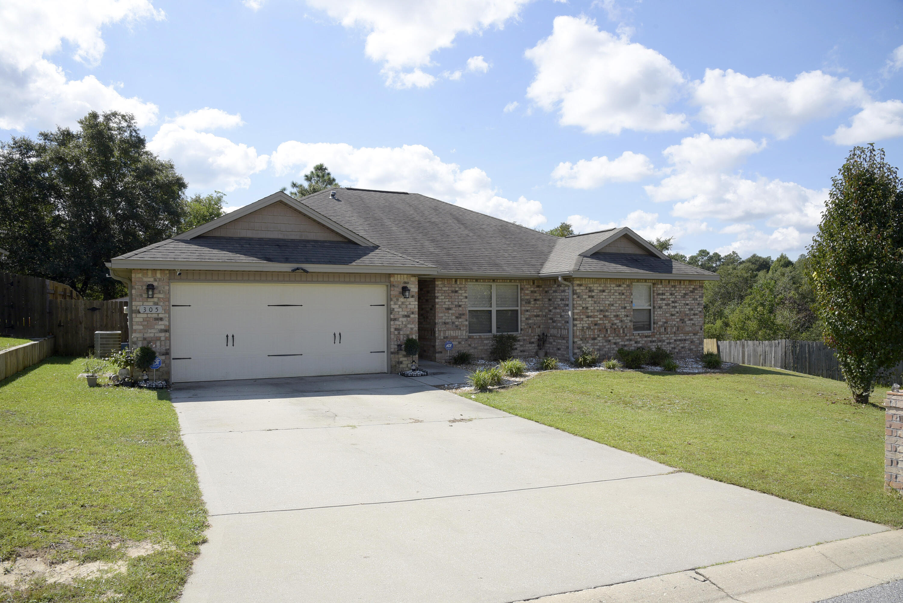 PRICE REDUCTION! Lovely home in northeast Crestview's Trailwoods Estates neighborhood. The home has a SolarEdge energy system installed at a cost of over $30,000 that may save you up to 70% on your monthly electric bill! Plus, the system is completely paid for and the solar panels are not visible from the front of the home! 4 bedrooms, 2 baths and an open living area with a double tray ceiling  provide a spacious feeling. Beautiful kitchen with custom cabinets, granite countertops, long breakfast bar and stainless steel appliances and roomy adjoining eating area are yours! Lovely master suite with walk in closet, master bath with separate shower, garden tub, double vanity and granite counter tops. Recessed lighting in some areas and a neutral paint scheme make this home very inviting. The second bath features a single vanity, shower and tub. The privacy fenced back yard has a large storage shed and an open patio attached to the rear of the home. Only one next door neighbor as there is a pond on the west side of the home and a green belt to the rear. Lawn irrigation system is in place as well as Orkin's in ground pest traps. Contract in place for Orkin routine pest control visits. The control panel for the ADT Alarm system will remain with the home. The balance of the system and electronic door bell do not convey.