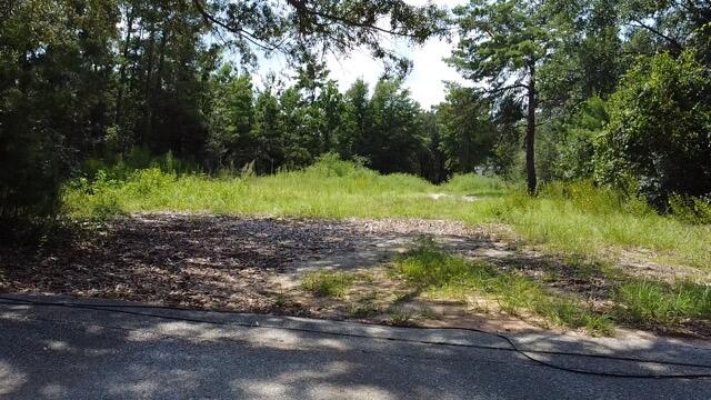 UNDER CONTRACT WITH 72 HOUR KICKOUT CLAUSE.  Cleared, buildable lot near 98 and East Bay Blvd. 
**Must See*** lot with location that has convenient access to EVERYTHING including great schools, shopping, groceries, military bases, medical and less than 10 minutes from famous, beautiful Navarre, FL beaches. Lot is high, dry with no wetlands. Lot previously had a mobile home. Water and sewer are in place with a power pole at the corner of the lot. Turnkey lot for a mobile home or framed construction.