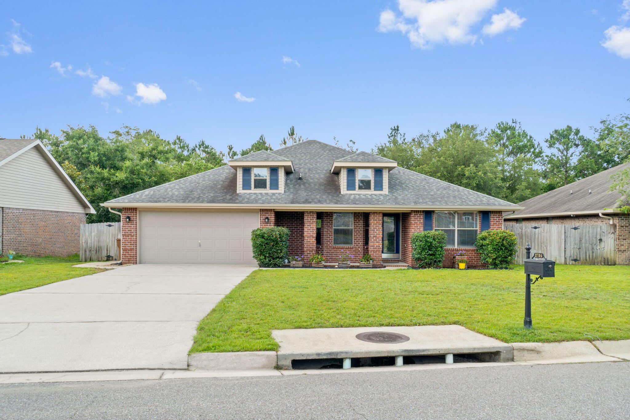 *Back on the market by no fault of the seller or house* Welcome home to this gorgeous move-in ready 4 bedroom home in the popular Navarre neighborhood of Waterstone on almost half an acre (the property extends far past the fence!) with a peaceful creek and a back property line that borders Tom King Bayou! This all brick beauty has an inviting front porch and leads you to a gorgeous interior complete with luxury vinyl plank flooring that extends from the entryway throughout all the common areas (living room, kitchen, dining space, interior laundry room, and hallway. The lovely and well appointed kitchen features stainless appliances, a kitchen island, and pantry, and overlooks the massive living room. The split floor plan features three bedrooms and a full bathroom on one side of the house, each with ample closet space, and a spacious owner's bedroom with a trey ceiling on the other. The en suite bathroom has double vanities, a walk in closet, soaking tub, and a newly installed stunning walk in tiled shower with river rock flooring, custom tile, and a glass door! Outside you'll find a lovely back deck overlooking the creek, perfect for entertaining, providing you plenty of privacy, and a fenced in yard for part of the property. Windows were updated in 2019, water heater replaced in 2020, HVAC replaced in 2021.Current termite bond in place for preventative treatment and protection. HOA is only $125/year. Survey available. Enjoy being close to Navarre's gorgeous white sandy beaches and emerald green waters just a short drive to Hurlburt Field.