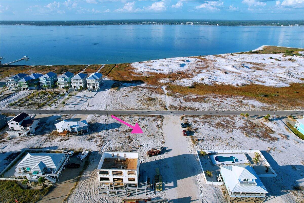 This one-of-a kind, .34-acre homesite is directly across the street from public beach access! Come see all of the breath-taking views that can be all yours with unlimited possibilities to realize your dream on this amazing lot. Just slightly over a third acre, this corner lot faces the sound with obstructed views from the front. The road and parking area on the eastside, afford you limitless opportunities to create views and outdoor spaces overlooking the gulf as well. No need to pack your car to drive to the beach, just walk outside your front door to the peaceful sound-side beach, or out of the back door to the public access of the serene, calming, gulf beach! Imagine what you can create as your dreams become your reality!