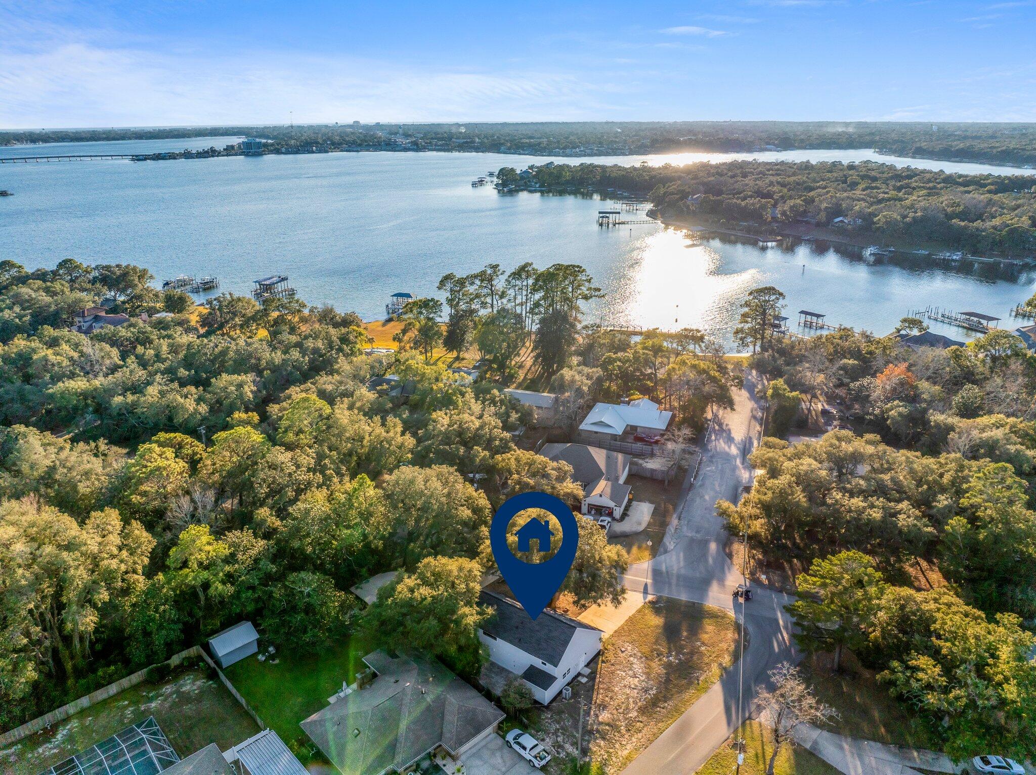 $125,000 in RENOVATIONS - COMPLETELY REMODELED - NO HOA & one minute to Poquito Bayou BOAT RAMP on the same street which is perfect for families and boating enthusiasts! This property provides ample space for parking a boat and trailer while still offering plenty of room for guest parking. As you enter the home, you're greeted by a open space connecting the living room to the dining room, ideal for entertaining. The renovation includes new LVP floors, new French doors, and a stunning kitchen with brand new quartz countertops. The kitchen features stylish blue jean (gray/black) lower cabinets that pop against the white upper cabinets, and stainless steel appliances. All bathrooms have been fully modernized, with the master ensuite boasting double vanities and a new shower.
The home's interior also benefits from all-new electric wiring, new electrical panel and can lighting throughout, complementing the new blonde LVP flooring and freshly painted white walls. Each room is equipped with new ceiling fans, including a large accent fan in the living room, enhancing both comfort and style.  Upstairs, a large loft overlooks the main living room, perfect as a second living area, game room, or study, especially for older children.
For safety, the home has been fitted with new smoke detectors throughout. It features two bedrooms downstairs, each with its own dedicated bathroom. The master bedroom on the first floor includes a seating area that can serve as an office space or reading area offering direct access to the back patio. The guest bedroom downstairs not only has its dedicated bathroom but also built-in bookshelves and a charming waterview. This area could potentially be converted into a guest room as it has a separate entrance.
Outdoor living is equally impressive, with front and back patios, an outdoor shower, and a carport that can double as a workshop with dedicated storage space. The property's recent upgrades include a new roof for both the house and carport. This property is an ideal choice for those seeking a modern living experience in a serene setting with large trees and outdoor entertainment spaces on a corner lot, with easy access to local amenities and recreational activities. Poquito Bayou Boat Ramp offers access to the bayou, pavilions with picnic tables, grills, swimming and a portable restroom.  Request a full list of renovations from your favorite Realtor!