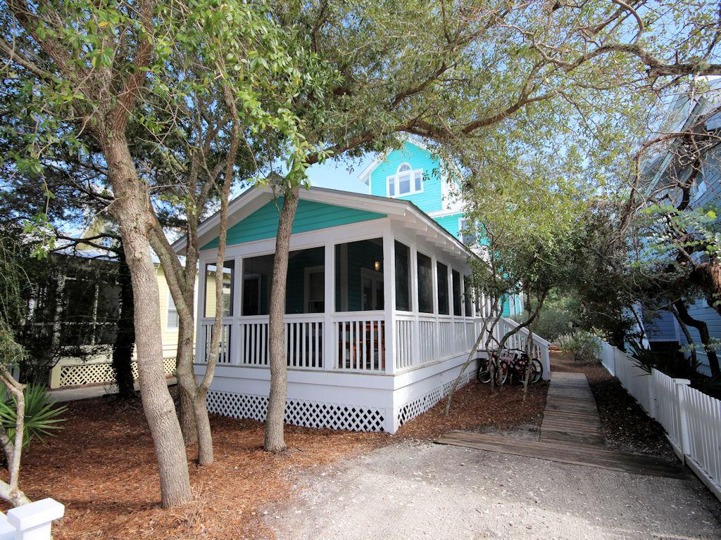 As they say- Location! Location! Location. Only 3 lots in from County Highway 30A, less than a five minute walk to the beach. This traditional Florida beach cottage is the perfect place to spend your family summer vacations. The front screened porch wraps around the side of the cottage and serves as additional outdoor dining. Enjoy your morning coffee as the sun peeps in through the shady oaks. The inside shower is easily accessible from the porch to shower off the daily beach sand. Galley kitchen with tile breakfast bar opens to dining and living area. Covered porch off kitchen overlooks the back yard. First level also features two guest bedrooms with French doors that open on to the porch. Between the bedrooms is a full bath. Master bedroom on second level with full bath and private porch. Children will want to hang out in the enclosed tower on the third level with balcony and gulf views. Baths recently updated with marble and subway tile, natural pine floors have been refinished, new window treatments added and updated furnishings. Onsite private driveway. Room to enlarge and add guest cottage.