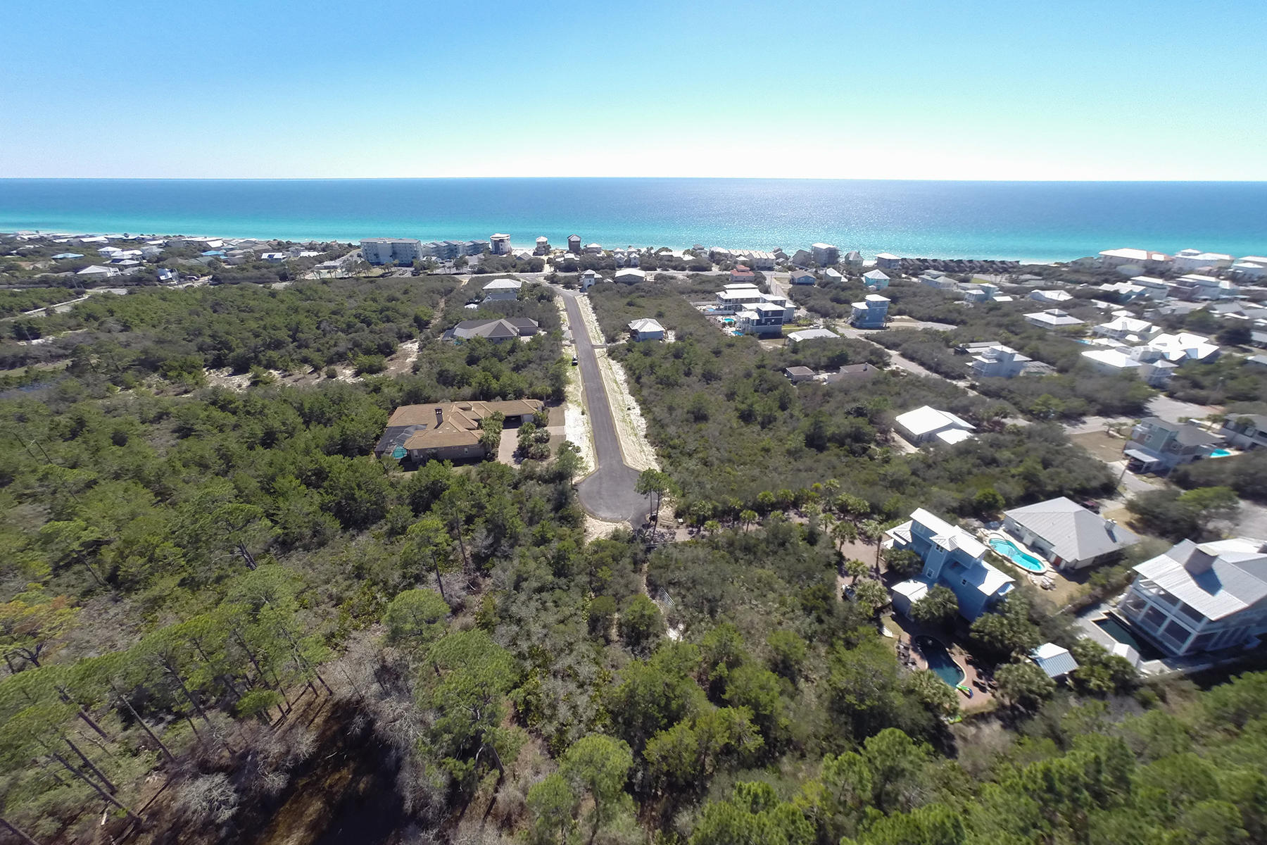 Set on a cul-de-sac, this lot measuring approximately 125 feet wide by 125 feet deep backs up to woodland at the Tom Fazio designed Camp Creek Golf Course. Deeded public Beach access is located just under a quarter of a mile away across 30A from Brenda Lane. And just over a quarter of a mile away is WaterSound Parkway, which will eventually lead to Northwest Florida Beaches International Airport. Shopping, dining, and seasonal entertainment is located close by in Alys Beach and Rosemary Beach on the popular east end of Scenic Highway 30A. No HOA dues or build out time.