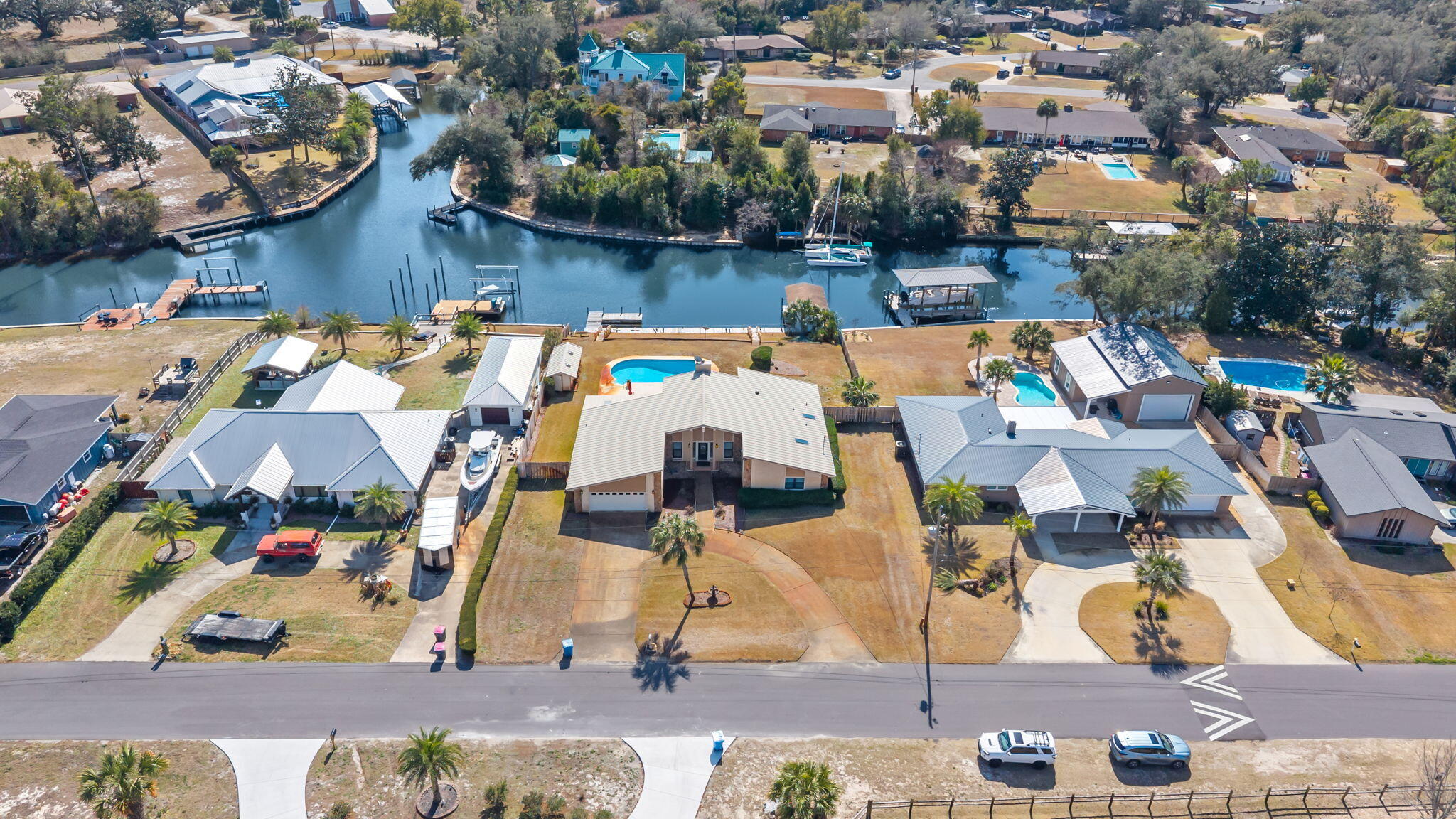 Welcome to an exceptional opportunity to own a waterfront home in the desirable Kings Point area, offered under $600,000 with a POOL and NO HOA! 

Situated on deep water along a wide canal, this highly desirable homesite offers higher elevation, expansive water views and quick access to the Bay and Gulf within minutes. With approximately 110 feet of water frontage and located on a large canal opening, the property provides panoramic water views and excellent boating access. 

Enjoy fishing from your private dock or take a short boat ride to the open Bay and on to Shell Island. This central Panama City location also places you just minutes from Publix, shopping, dining, and approximately 15 minutes from the white sandy beaches. This single-level home offers just over 2,300 square feet with 3 bedrooms and 2 bathrooms and a cozy sunroom. Inside, vaulted ceilings and dentil molding add character, while a stone fireplace anchors the living room overlooking the pool and canal. The open layout includes a spacious kitchen with newer stainless appliances, center island, pantry, and an eat-in breakfast nook with water views. A formal dining room overlooks the pool, and a sunroom provides additional access to the outdoor living area. 

The oversized primary suite faces the waterfront and includes a walk-in closet, dual bath vanities, separate makeup vanity, and walk-in shower. Two additional bedrooms feature walk-in closets and share a guest bath. Additional highlights include a spacious laundry room and a two-car garage. 

Outdoors, enjoy a covered porch, private pool, circular driveway, and a location directly across from the community park. This well-maintained home presents an incredible opportunity to personalize a waterfront property with year-round boating, fishing, and sunset views right from your backyard. 

Waterfront living in Kings Point is now within reach! Start living your best waterfront life today in Panama City, Florida!