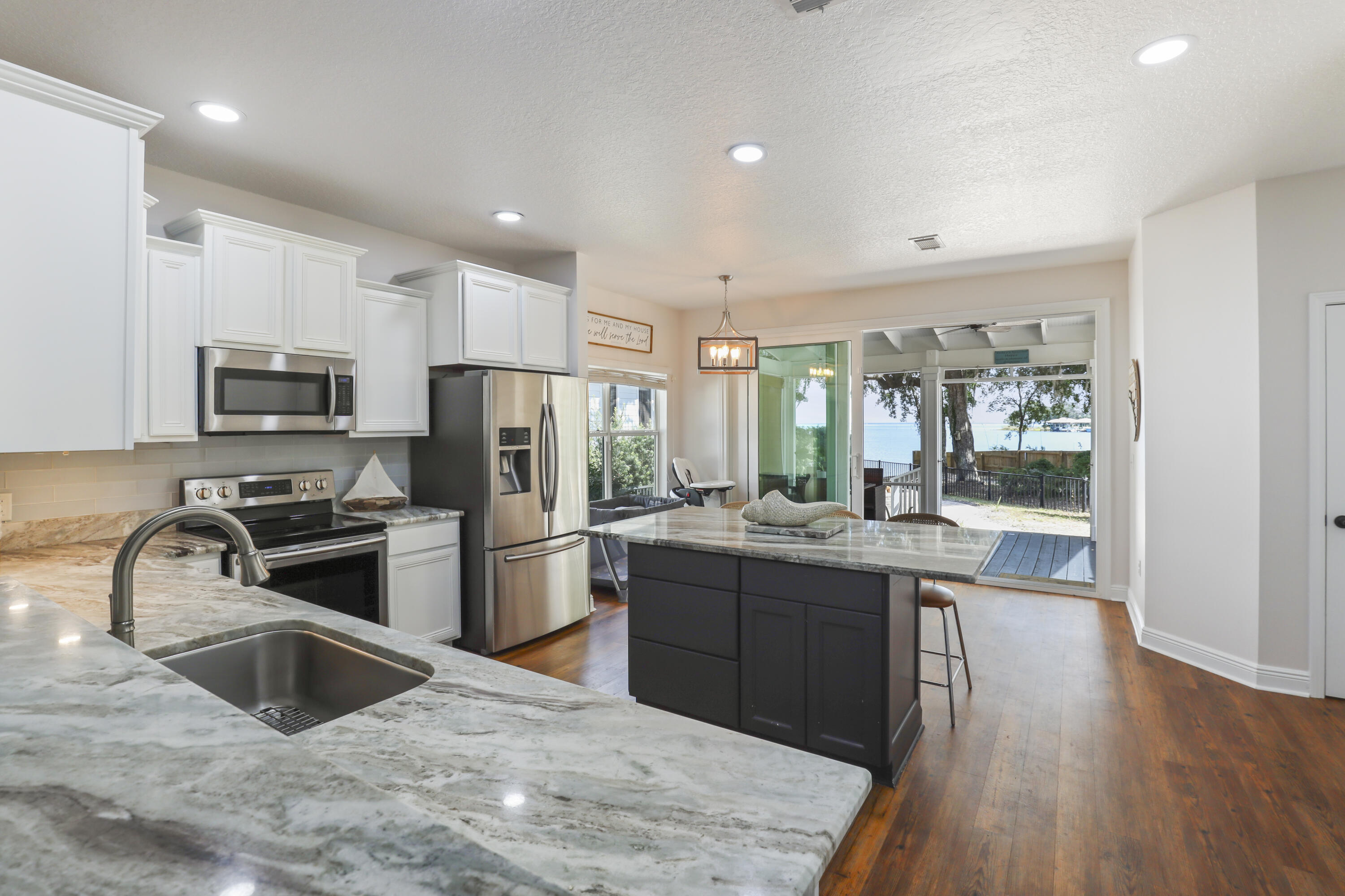 WOW!! Beautiful WATERFRONT home and Lifestyle on the Bay offer Views of the blue water off Mack Bayou. Nestled in Sacred Oaks, a neighborhood that lives up to its name with grand oak trees draped in southern moss, this enclave Excellent located close to upscale Grand Boulevard shops and the iconic white sands of Florida's Scenic Emerald Coast Highway and 30A.
Beautifully maintained 3-bedroom, 2.5-bath home provides an open living, dining, and kitchen design while highlighting the stunning water backdrop. The glider window opens to a screened porch and patio ready with a fire pit for smores. This home is perfect for watching dolphins, coastal birds, spectacular sunsets, and sunrises. 
Enjoy watersports right from your backyard. Boat ramp next door with no motorboats to keep the calm peac environment. Adjacent to your backyard is a boat launch to enjoy paddleboarding, fishing, canoeing, or mooring your own boat and exploring the bay. One home site away is a large boat dock for owners to enjoy.

With fresh paint, updated kitchen, and your own tranquil water view home, you may create a move-in-ready paradise! There are endless views from this home, including water views from your primary bedroom! Located on a quiet cul-de-sac with a reasonable HOA.

This pet-friendly community is a short golf cart ride to dining, entertainment, neighborhood trails, Publix, and ample beaches near. There is also easy access to three nearby airports.

Whether savoring morning coffee on the porch or relaxing by the fire pit at day's end, this property delivers a rare combination of natural beauty, privacy, and convenience. A one-year home warranty adds peace of mind.

The neighborhood is north of Hwy 98 and about 3 miles to the nearest white sand and clear water beaches. Away from traffic and noise while also minutes from the popular Bay Town Warf, Grande Shopps, outlets. and so much more.

The Sacred Oaks covenants do not allow short term Rentals as the community is a tranquil water front community. This perfect beach house is awaiting your new family memories. COMES WITH A ONE YEAR HOME WARRANTY.