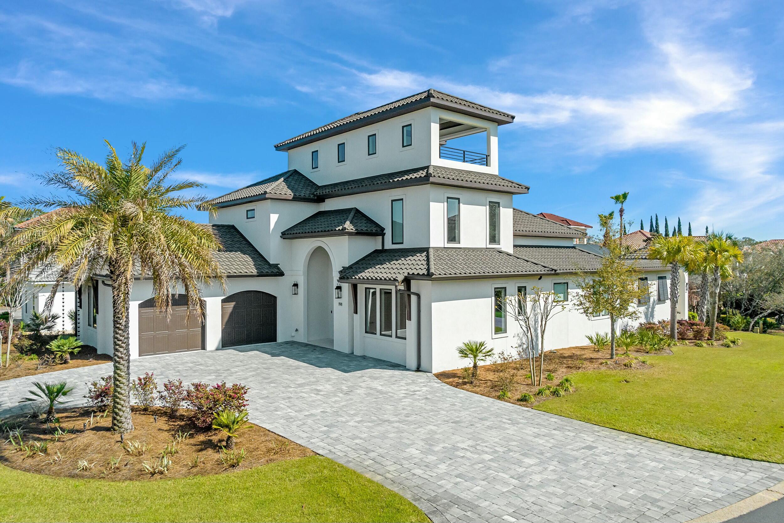 Experience the pinnacle of coastal living in this newly constructed home, a rare find in the sought-after gated community of Bellamar. Designed for both comfort and elegance, this rental-restricted enclave offers private beach access and breathtaking Gulf and golf course views from the third-floor deck.  
Step inside to discover high-end finishes throughout, including engineered wide-plank French Oak hardwood flooring, custom cabinetry, and solid core doors for added durability and noise reduction. The home's thoughtful design includes a central vacuum system with a hideaway hose, an elevator for seamless access across all floors, and exquisite crown molding. The entryway, exterior entry, and lanai feature beautifully stained pine ceilings, adding warmth and character to the space. The chef's kitchen is a masterpiece, boasting Quartzite countertops, Signature Kitchen Suite appliances, and an induction cooktop with a convection double oven/microwave. A spacious island provides additional storage on the stool side, while the built-in refrigerator/freezer includes both standard ice cubes and specialty ice balls.  
Smart home and energy-efficient features include dual Navien tankless water heaters with a hot water loop, a Generac whole-house generator, and full-house foam insulation, including the garage. Impact-resistant doors and windows provide added peace of mind, while the Decra stone-coated metal roof ensures durability with low maintenance.  
Outdoor living is just as impressive, with a 14 x 25 saltwater heated pool enclosed within a screened lanaifully app-controlled via Hayward. Shellstone pool decking, an outdoor shower, and coded side yard entry door enhance both convenience and security. Thoughtfully placed accent lighting highlights decks and outdoor spaces for an inviting ambiance.  
The first-floor primary suite is a private retreat, offering double door outdoor access, dual vessel sinks, a spa-inspired shower with dual and rain shower heads, and a spacious walk-in closet with washer/dryer access. Upstairs, a second-floor office features built-ins and space for an additional closet, while a massive spray-foamed unfinished attic offers over 800 sq. ft. of potential.  
A two-car garage with epoxy-coated floors provides easy cleanup, while pull-down stair attic storage adds convenience. Every element of this home has been designed with luxury, functionality, and longevity in mind.  
Don't miss this rare opportunity to own a practically brand-new home in Bellamar with unparalleled features and stunning views. Schedule your private tour today!