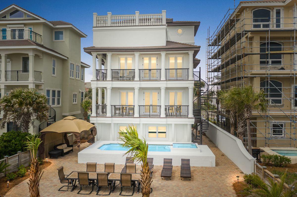 Pristine gulf vistas accentuating a prominent beach front positioning in the heart of Destin Florida characterize this sprawling four story gulf front retreat in the gated neighborhood of Dunes of Destin. Newly remodeled and beautifully decorated, this masterful coastal retreat has been completely refreshed and amenitized with notable features including a large gulf front pool and private beach walkover as well as a fourth story entertaining deck offering panoramic views over the emerald green waters and white sand beaches of the Gulf of Mexico. This property offers projected gross annual income exceeding $300,000 annually and features all new interior & exterior paint, new flooring throughout including new tile on all porches, new concrete tile roof, newly remodeled interiors including but not limited to refreshed bathrooms, fully renovated kitchen with new professional stainless appliances & custom cabinetry, new furnishings throughout as well as an added bathroom on the first level to accommodate a kids bunk suite. There are four full king suites and an additional fifth bunk room on the first level. There is a private elevator, however it is not available for guest use. The master suite is oversized and located on the third level with it's own private rear facing covered balcony and private ensuite bathroom accentuated by floor to ceiling glass windows allowing for 180 degree views over the emerald waters of the Gulf of Mexico. This property also yields a garage and ample parking in the driveway. It's currently on a rental program and would make an excellent transitional property with optimal space to yield short term rental income. 

Dunes of Destin is a gated enclave located in the heart of Destin, Florida with excellent proximity to world class dining, shopping and local entertainment as well as the famous Destin Harbor with Marina/boating access nearby.