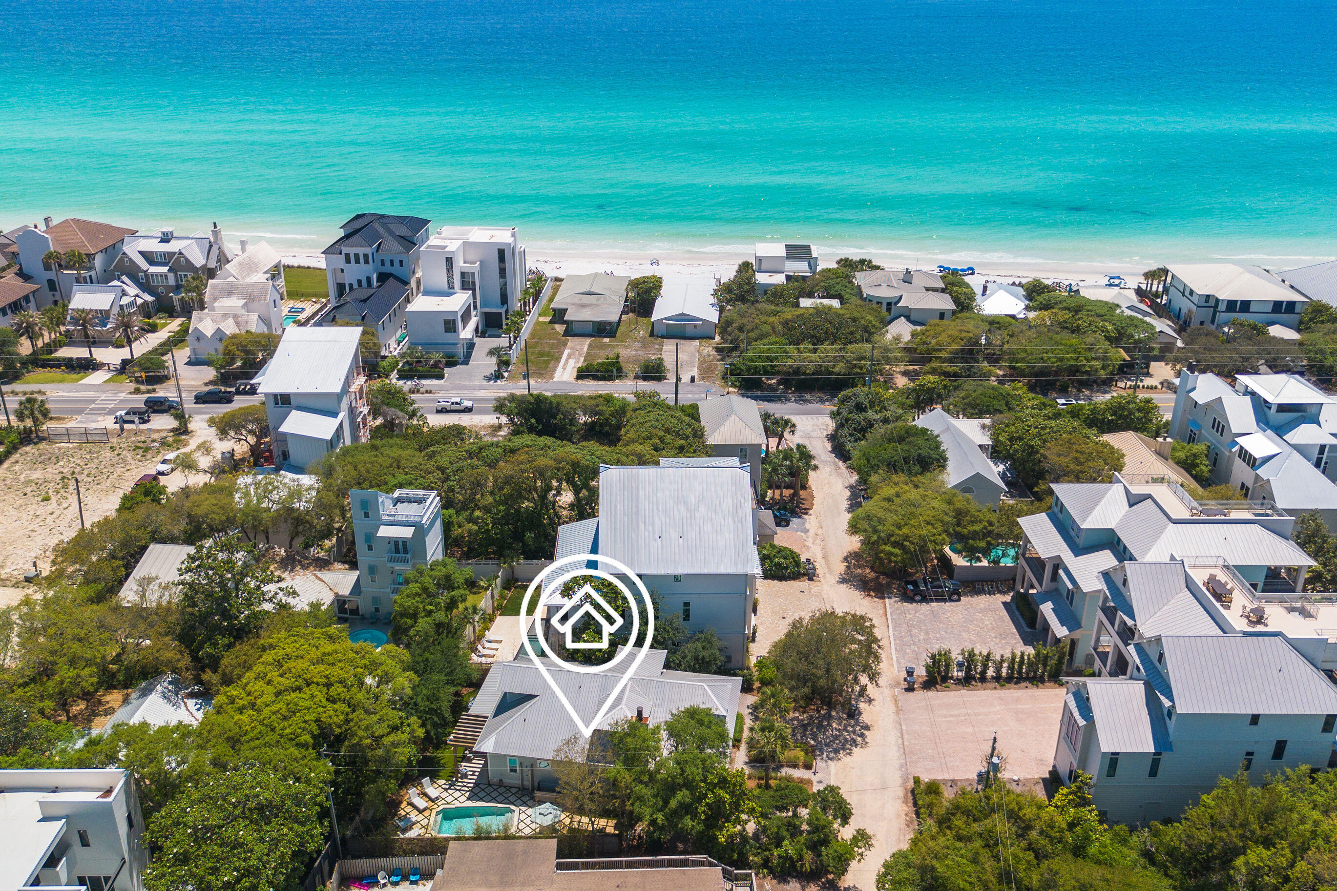 Welcome to 50 Camellia Street — a home where Southern charm meets coastal living in the heart of Old Seagrove Beach, just a bike ride from the energy of Seaside and WaterColor and just steps to the serenity of the Gulf. 

This property is a custom-crafted Southern Living plan, built by renowned 30A builder Mark Bakane. This refined coastal retreat seamlessly blends notes of timeless lowcountry architectural features with relaxed beachside elegance.

From the moment you arrive, the home's craftsmanship is evident. Inviting expansive front porches, natural wood accents and exterior gas lanterns illuminate the exterior beauty of this home. Step onto the storybook front porch where timeless Southern charm meets laid-back coastal luxury. Framed by classic shutters and natural wood elements this space offers a private, breezy retreat perfect for morning coffee or evening cocktails. Tongue-and-groove ceilings, woven seating, and coastal-inspired lighting set the tone for relaxed gatherings with friends and family. Whether you're dining alfresco at the farmhouse-style table or unwinding beneath the ceiling fan with a good book, this inviting porch feels like an extension of the home's heart - warm, welcoming, and wonderfully serene.

Inside, the home opens to a large living space framed by shiplap walls, rich wood flooring, and designer lighting. The gourmet kitchen is a showstopper, outfitted with custom cabinetry, top-tier appliances, marble countertops, and an oversized island made for entertaining.

The floor plan offers multiple living areas, generous guest accommodations on the first and second levels, and a private owner's suite that feels like a true sanctuary with spa-inspired finishes.

Outdoor living is elevated with generous porches and a tranquil backyard space. The backyard is an entertainer's dream, centered around a resort-style pool that exudes luxury. Framed by elegant stone pavers set in lush green turf, the design strikes a perfect balance between sophistication and coastal charm. Ample space for lounging under the sun surrounds the water, while a pergola-covered seating area invites relaxed gatherings or evening cocktails by the pool. Whether you're hosting summer celebrations or enjoying quiet mornings, this thoughtfully curated outdoor oasis elevates everyday living.