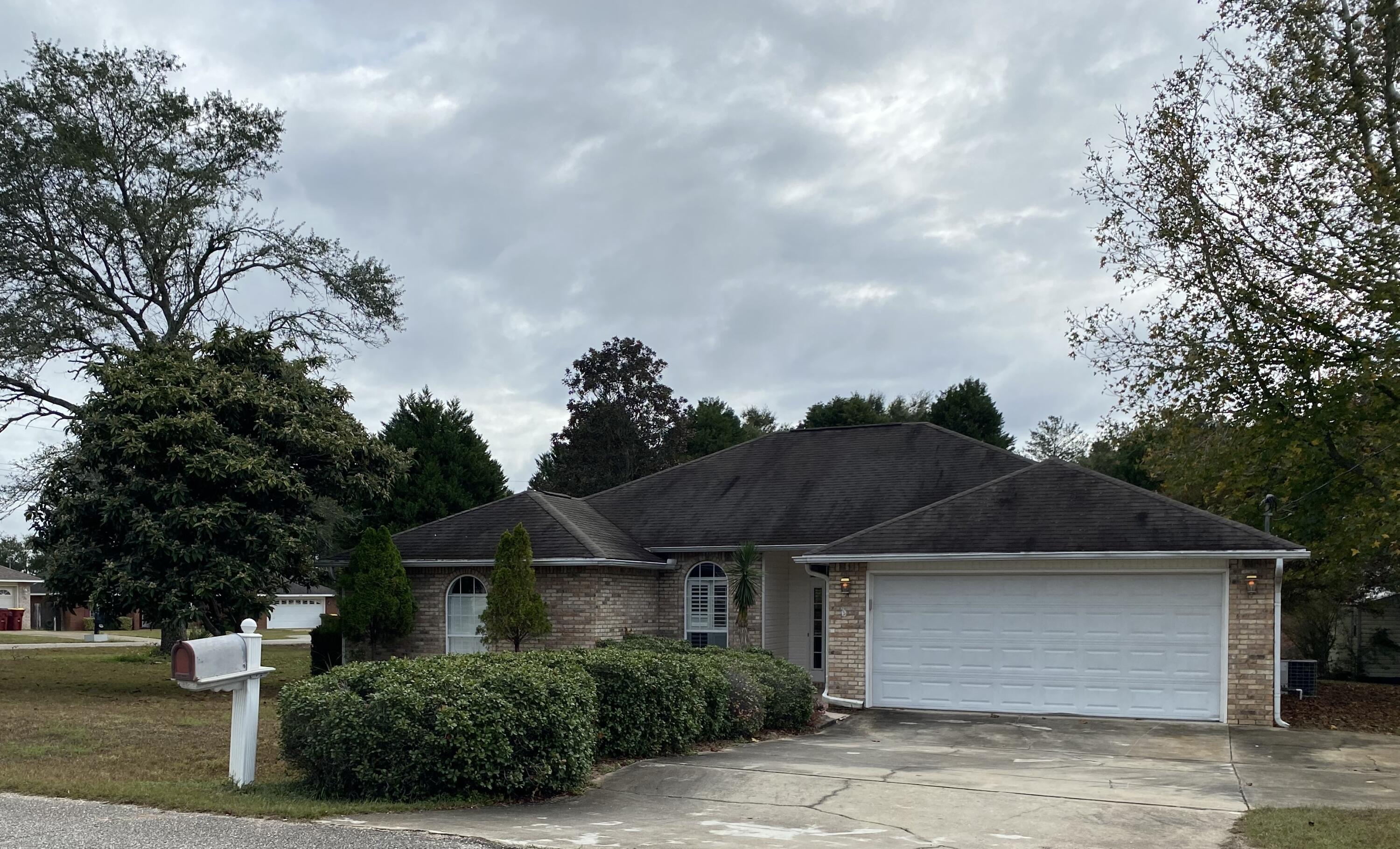 South of the interstate.  Short commute to the local bases.  This lovely all brick 3 bedroom 2 bath is located on a nice size corner lot.  Beautiful landscaping is the first thing you will notice when you arrive at the property.  Upon entering the property you will be amazed by the open feeling you will get in this split bedroom floor plan.  Tile in the kitchen and bathrooms.  LVP in the main living are with a cozy fireplace.  Enjoy our Florida sunsets in this screened in patio.  Large deck for entertaining you family and friends.  Also a large out building for storage.