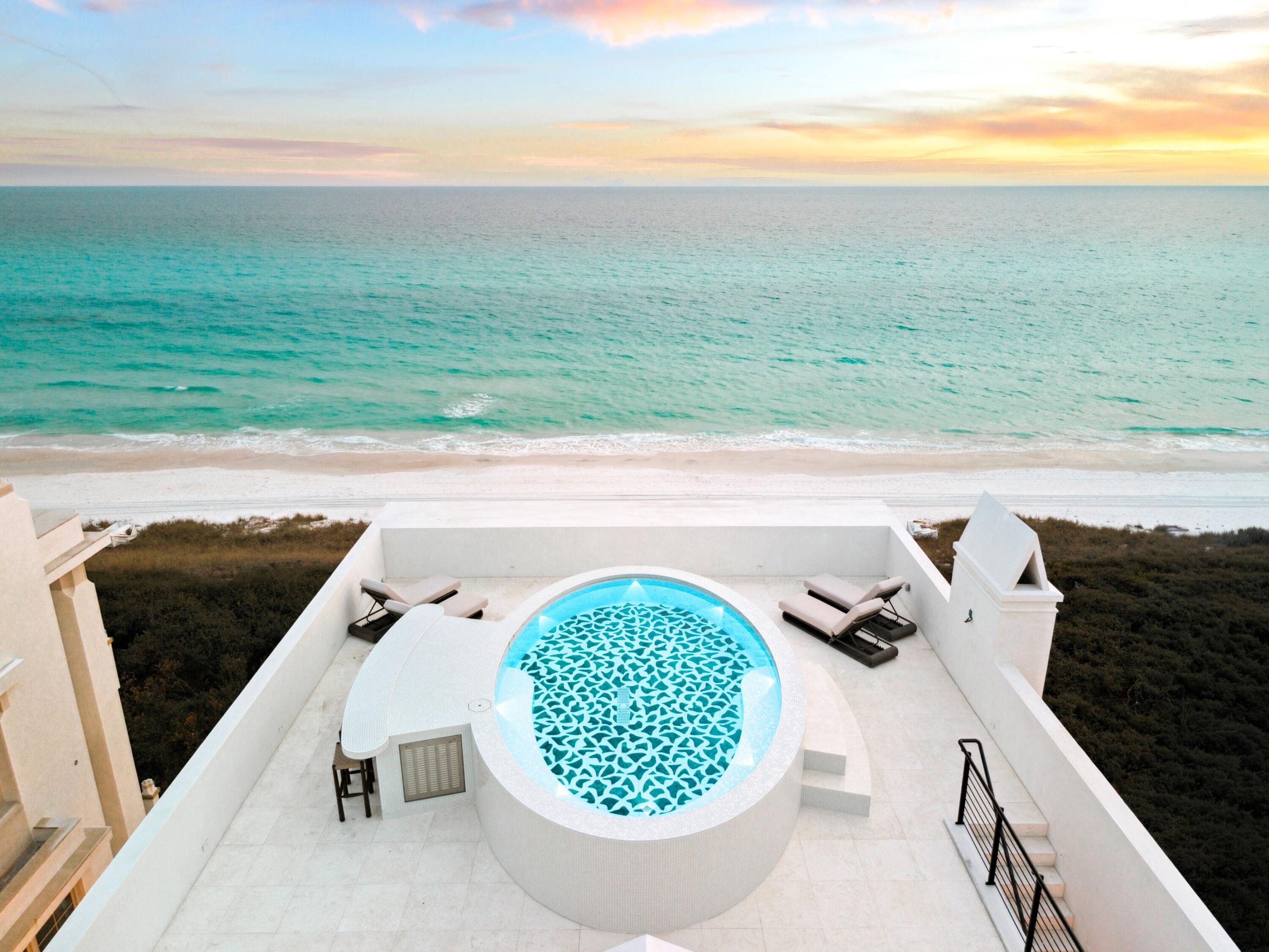 Property is under contract subject to a seventy-two (72) hour kick-out clause. Along the pristine shores of Florida's Emerald Coast, where architectural restraint meets sun-washed serenity, Alys Beach unveils its newest Gulf-front jewel. Rising above a 53-foot expanse of private beachfront, this newly completed residence represents one of the most ambitious design collaborations ever undertaken in the community. Conceived by A Boheme Design under the direction of Darrell Russell and brought to life by Gulfview Construction, the home is an uncompromising study in precision, proportion, and permanence. Constructed entirely of solid concrete, including a concrete roof, the residence spans more than 5,200 square feet of interior living space and an additional 1,800 square feet of outdoor environments. Its generous gulf-front width, rare even by Alys Beach standards, allows the architecture to fully embrace the horizon, bathing every level in shifting bands of light while maintaining exceptional privacy and quietude.

A secluded courtyard pool sets the tone on the ground level, offering a calm, cloistered retreat framed by Venetian plaster and stone. Guest suites, a lounge and bar, and a dedicated beach-entry laundry room turn the entire floor into a refined hospitality wing.
The main living level is a sculptural, light-filled expanse where floor-to-ceiling glass retracts to unify the indoors with a gulf-front terrace. A glass-enclosed, marble-accented wine installation anchors the space as an art object, complemented by a custom European kitchen defined by clean lines, integrated appliances, and concealed storage. Entertaining flows seamlessly from intimate to elevated, supported by a dedicated scullery tucked discreetly out of view.

The third level delivers a private world of its own. The primary suite occupies the gulf side, where dawn and dusk unfold across a refined palette of stone and plaster. A custom dressing room, guest suite, office, and a secondary bar complete the floor, all connected by hallways engineered to protect both views and privacy.

Above it all, a rooftop terrace creates an experience rarely found on the Gulf Coast, a multi-level aerie anchored by a custom mosaic pool featuring a commissioned artisan inlay. With an outdoor kitchen, bar, sun lounges, and uninterrupted 360-degree vistas, the terrace functions as a private resort suspended over the shoreline.

Whole-home automation, high-efficiency mechanical systems, and impact-rated window and door assemblies ensure that the home's technical performance matches its architectural ambition. Every detail, material, and proportion reflects a commitment to longevity, craftsmanship, and intent.

Set within Alys Beach, a community celebrated for its design integrity, walkability, wellness offerings, and carefully curated town centerthe residence is as much a lifestyle statement as it is a home. It is a rare Gulf-front sanctuary crafted for those who see architecture as art, and who understand the lasting value of a home built without compromise.