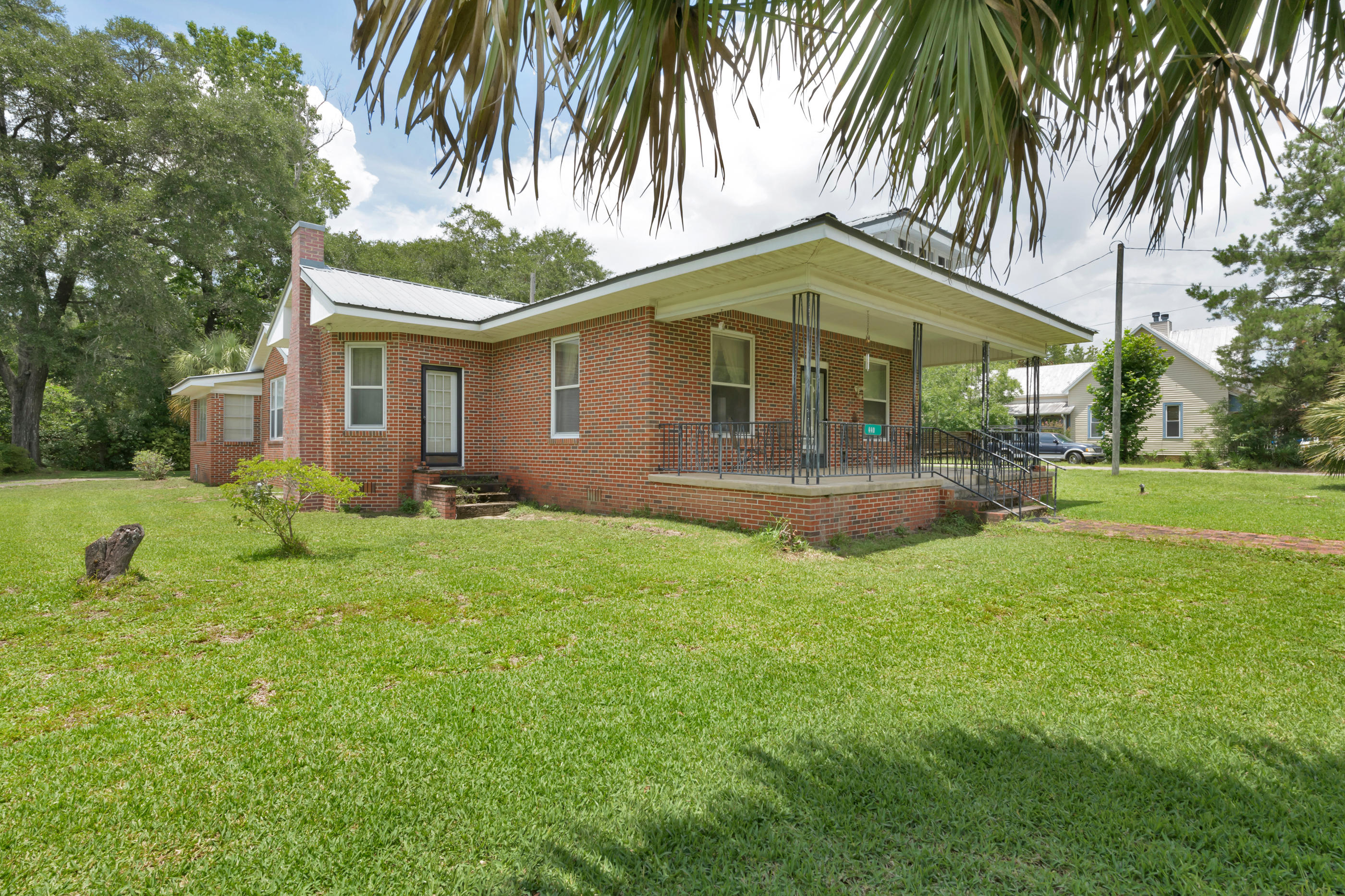 Beautiful historic brick home in the heart of Defuniak Springs on a large corner lot. All appliances included in sale, new back porch, metal roof in great condition, Florida room with AC , this home has two living areas as soon as you enter the front door and original cabinets in the kitchen!
Home has a detached 2 car garage, another small shed and 2 driveways, one on each side of the home. There is plenty of room for storage and workspace.
Adorable front porch with new concrete and a nice walkway to the mailbox and main road.
There is so much character in this unique home, it is truly a great, sound home to update or enjoy as is!