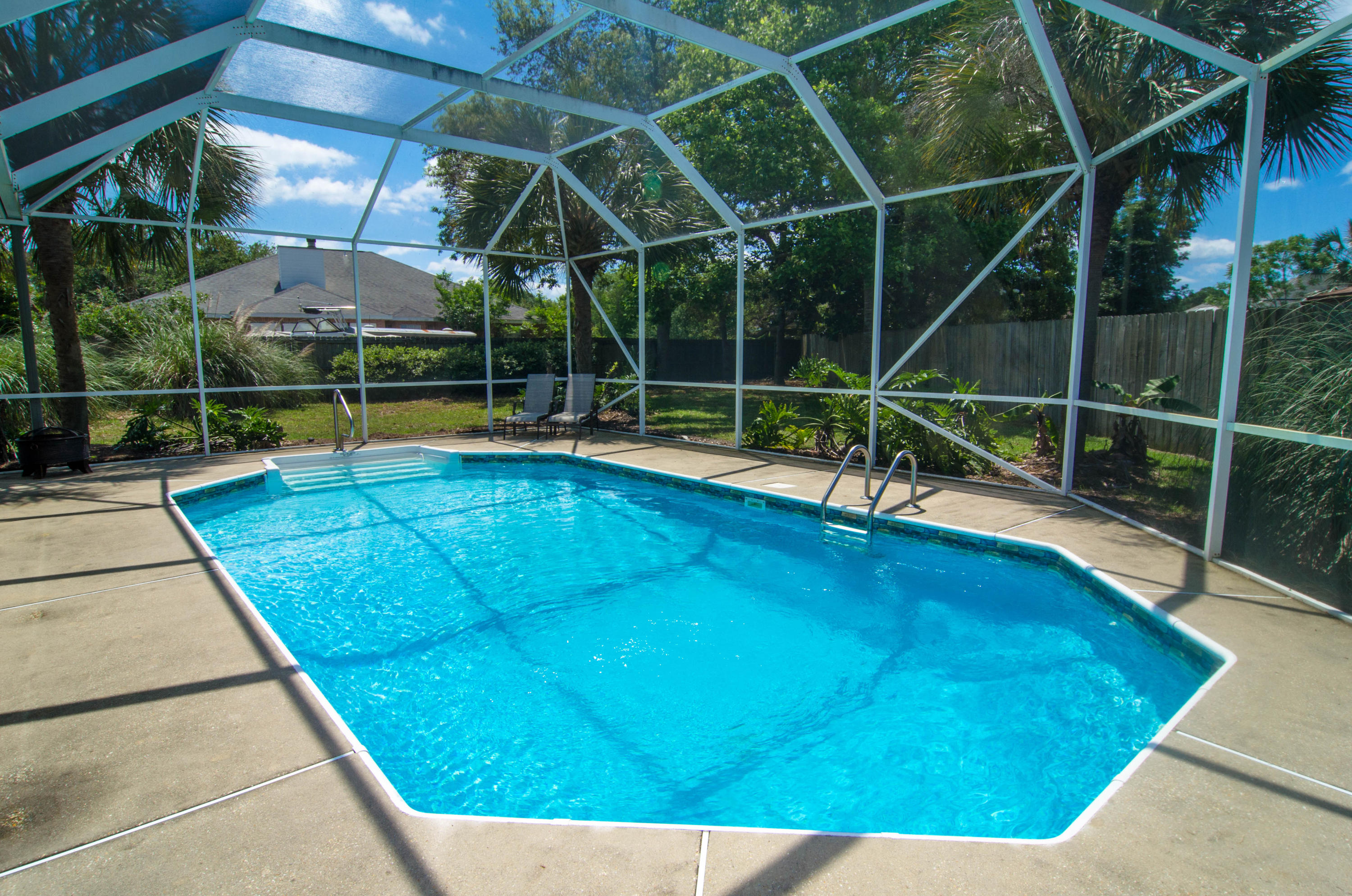 Beautiful 4 bedroom + office all brick home with a pool located in the desirable Indian Bayou neighborhood! This spacious home is open and inviting with loads of windows and natural light. A split bedroom floor plan, home boasts a large Master Suite with two walk-in closets, double vanity, whirlpool tub, separate shower and private sliding doors to lanai and pool. Three additional supersized bedrooms, 2 1/2 baths and separate office/den/playroom with french doors. Gourmet kitchen features a pantry, upgraded cabinetry with a built-in wine rack, a breakfast bar and a large kitchen dining area! Kitchen opens to the spacious great room complete with built-in's and gas fireplace. A screened lanai, sparkling pool and outdoor shower are only a part of the great outdoor living this home has to offer - don't settle for a postage stamp sized lot when you can have this large lot complete with lush and mature landscaping! The large, fenced backyard is perfect for children or pets. 2-car garage, plus air conditioned work or storage room (not included in square footage), makes storing seasonal items convenient. House is wired for surround sound inside and out.  Pool pump replaced 2 years ago and newer pool liner.  Enjoy the low HOA dues in the golf course neighborhood of Indian Bayou neighborhood that include patrolled security.  The owner of this home also qualifies for a greatly reduced season pass to the Henderson State Park beach access.