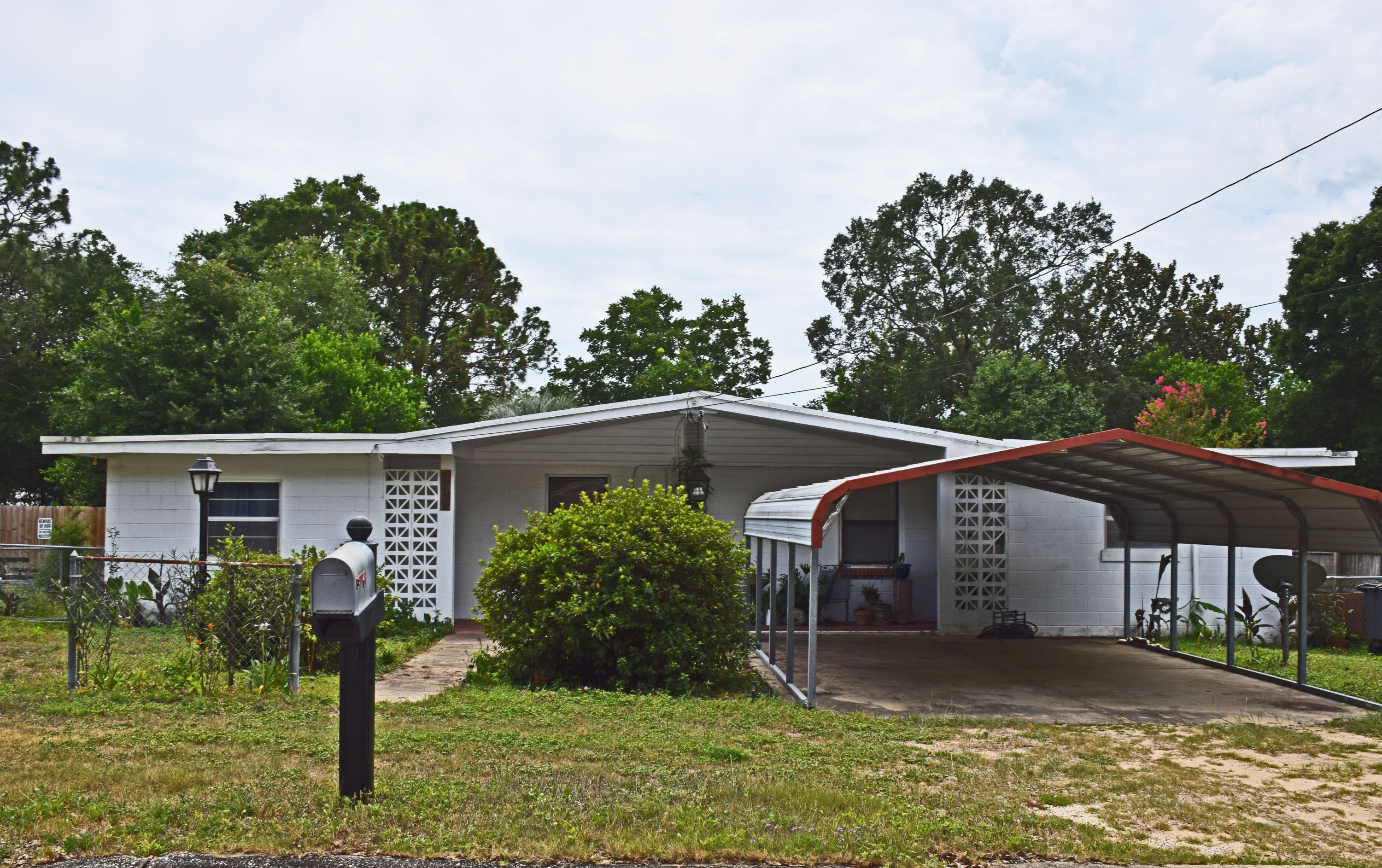 Concrete block home on quiet street. Repairs needed but lots of room to spread out. Central heat and air, all appliances. Baths and kitchen appear original as do the windows. Additional 12 x 60 concrete block building holding the laundry and a workshop.