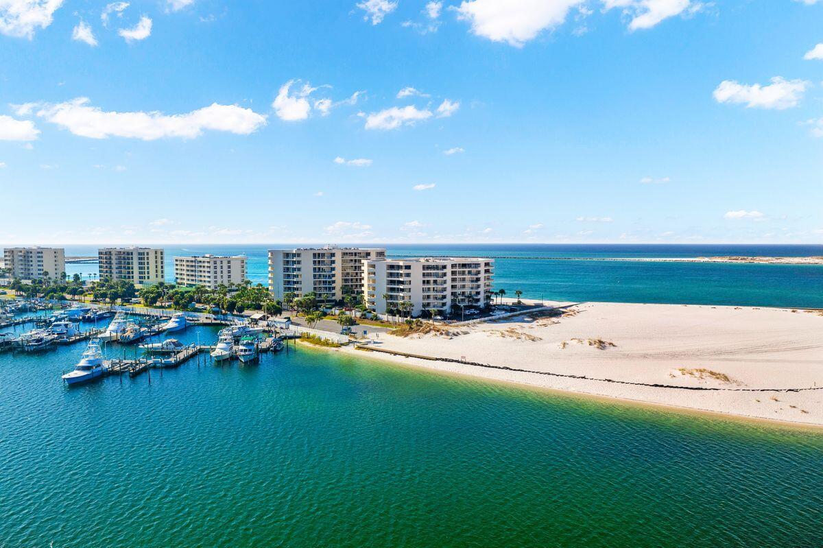 Gulf views abound from this updated condo in East Pass Towers. Enjoy views of the Destin Harbor, East Pass, and the Gulf of Mexico. You will enjoy the fitness center, club suite and large pool deck with pool and hot tub all on site. This condo features granite countertops, travertine flooring throughout, and stainless appliances. The open living, dining and kitchen are ideal for family get togethers and entertaining. Views of the water can be seen from every room. The living room, guest room and master bedroom all have access to the expansive balcony. Take in sunset views from your balcony overlooking Destin harbor and the Gulf of Mexico. The unit also features assigned covered parking and separate storage. This will make a wonderful second home, rental investment, or primary residence.