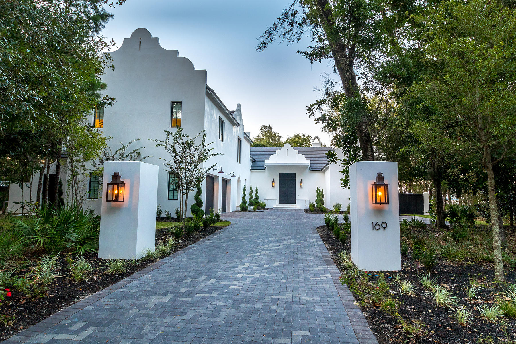 Builder Regal Stephens and Architect Tyler Doin raised and redefined the bar when they built this unmatched Beauty on the Bay. Located in The Estuary, a Bayfront community hidden behind never to be developed State Forest, 169 Ansley Forest Drive is like no other home. Just minutes to the beach, Seaside, the elementary, middle, and high school, The Estuary feels secluded, but is close to everything. Built on .6 acres, with huge Oak and Magnolia trees, this home offers tremendous space, views, privacy, and 100 feet of Bayfront serenity. Take the boat out to the gulf to go deep sea fishing, sit on the dock for cocktails and watch the sunset, or grab your paddle boards and hit the water. Return for a relaxing swim in the oversized 45-foot pool with spa. Wrap up your day with a hot steam in the huge Master bathroom steam shower. Come Fall, you can light a fire (inside or outside) and have dinner al fresco while watching your favorite football team play. Everything you need to relax, unplug, and unwind is included with this property - even a separate pool house for your guests. When you walk through the custom 13-foot front doors, you are greeted by floor-to-ceiling windows found throughout the entire backside of the home, offering you views from everywhere. The home is white stucco with a concrete tile roof, black accents, and flickering gas lanterns in front and back. The gorgeous light wood oak floors are wide plank with herringbone wood throughout the oversized foyer. Huge slabs of Statuary marble greet you in the kitchen that includes two dishwashers, a commercial Sub-Zero refrigerator, two ovens, a steam oven, a warming drawer, pellet ice maker, and a Wolf built-in coffee maker. The details in this home are endless. The barn doors are covered in custom metal, the powder bath is stunning with Schumacher "Queen of Spain" wallpaper, and the lighting throughout is the best money can buy. Let us not forget the walk-in, climate-controlled 500 bottle wine cellar. This home oozes with so much style, we can't possibly mention every detail. You must see it for yourself; but we warn you, you'll never want to leave.