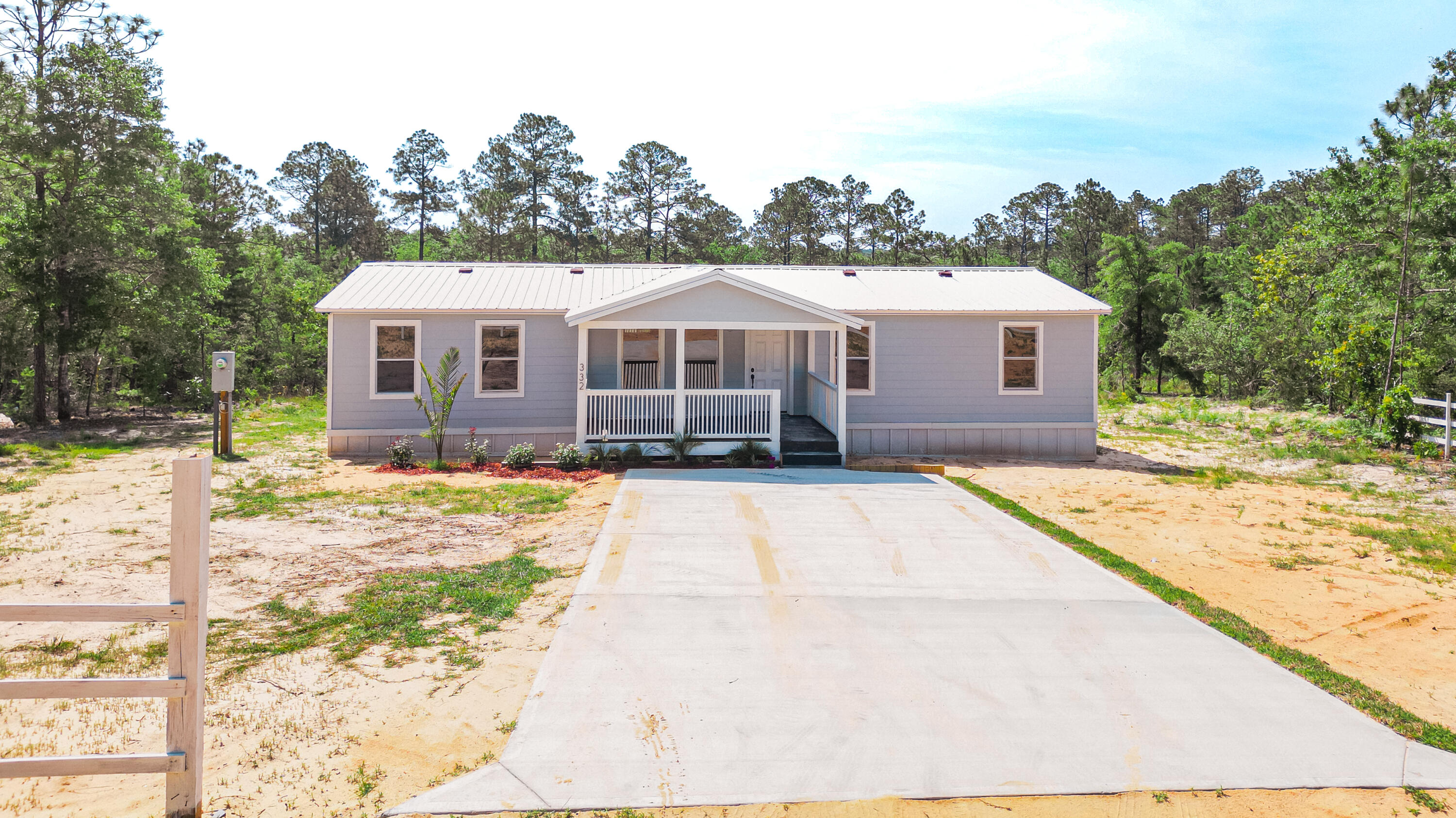 $10,000 PRICE IMPROVEMENT PLUS $10,000 SELLER CONCESSIONS.....to lower mortgage interest rate, put towards closing costs or a little bit of both. The latest upgrades include: 1) NEW HVAC, 2) NEW WOOD BURNING FIRE PLACE AND ATTRACTIVE TILING, 3) A NEW HOT WATER HEATER AND 4) NEW STAIRS FROM THE PORCH TO THE BACK YARD. Lending agent Cynthia Trisch, NMLS 2036370, Lending House, 850-462-3555 is offering attractive financing for this 'Subsequent Move Manufactured Home'. She also offers to the buyer who uses her services, a credit at closing of up to $650 to cover Home Appraisal Costs.  The home has a concrete driveway, 2 new covered porches and a metal roof. The exterior of the home is adorned with Hardy Board siding and skirting. The bathrooms have been upgraded with all-new self-closing cabinets, tiled floors and showers. LVP flooring throughout. The kitchen boasts natural wood cabinets, granite countertops, new appliances. Recessed lighting has been installed throughout the home, providing a modern and well-lit ambiance. Additionally, new ceiling fans contribute to improved air circulation and comfort. The interior has been freshly painted in a soft white color, creating a clean and bright atmosphere.

This manufactured home offers a harmonious blend of nature and a comfortable, stylish living environment in the coveted serene setting of Juniper Lake Estate. Beyond the boundaries of the property, you'll find a range of amenities to enjoy. Explore the nearby Juniper Lake Park, indulge in a game of golf at the prestigious Defuniak Springs Golf Club just moments away, or take a short trip to Ponce De Leon Springs State Park. This property strikes the perfect balance between privacy and convenience.

It's more than just a house; it's a retreat that promises a life of comfort and serenity. Don't miss the opportunity to make this enchanting property your own and create lasting memories.