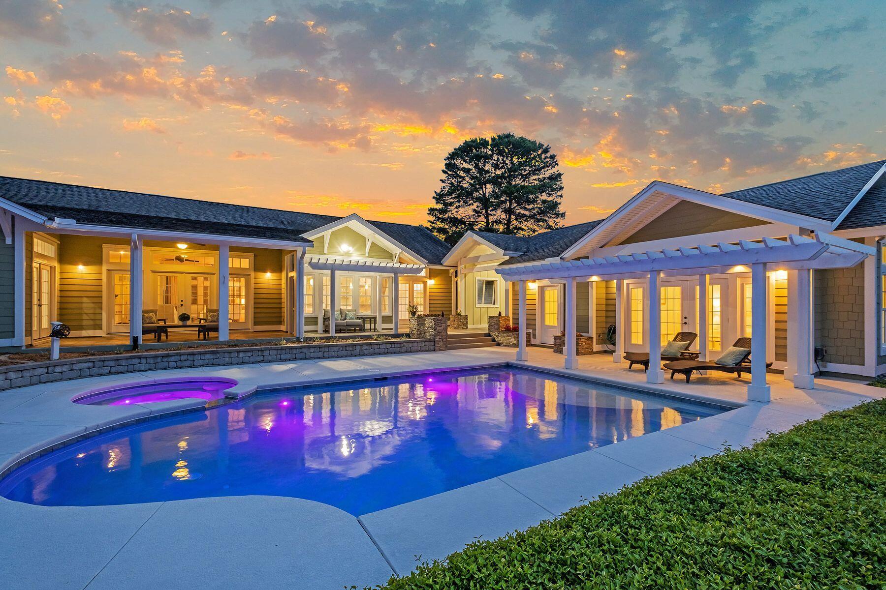 Situated on a mature half-acre lot on a quiet cul de sac, this elegant home boasts majestic lake and golf views. Enjoy an elevated and serene setting that captures this Florida cottage style with coastal design and color palette.  Follow the brick pavered driveway to an oversized three car garage and a flagstone pathway leading to the impressive covered entrance. Inside, this beautiful home exceeds expectations with gleaming hardwood floors, energy-efficient windows, custom drapes and a wall of custom bookcases for displaying family photos and treasures. Bathed in natural light, the open floor plan is ideal for entertaining. There is a wet bar and a generous chef's kitchen with a large granite-topped breakfast bar ideal for laying  hors d'oeuvres before dining. French doors lead to a spacious screened porch where a stunning view unfolds across the lake and holes eight and nine of the Santa Rosa golf course.  A covered outdoor kitchen with large stainless steel grill and gas burners lends itself to leisurely poolside barbecues. The heated pool and spa welcome you after a hard day on the links. The lush landscaping is showcased after dusk with custom accent lighting.  There is also a spacious 572-sq.-ft. guest house for accommodating guests in their own private space. Noteworthy extras include a 20 KW Generac generator, hurricane safe room built to Miami-Dade specifications, new water heaters and heat pumps with healthy air filtration. The three car garage also serves as a workshop with built in pine cabinets and extensive counter space affording ample storage for any car enthusiast or hobbyist.
 
There is an advantage of no HOA with no short-term rentals. Located within one of the highest elevated communities in the area, there are bike paths to the sparkling white sandy beach and Santa Rosa Beach Club. Shopping and dining with friends at Gulf Place are just minutes away along this coveted stretch of Scenic Highway 30A.