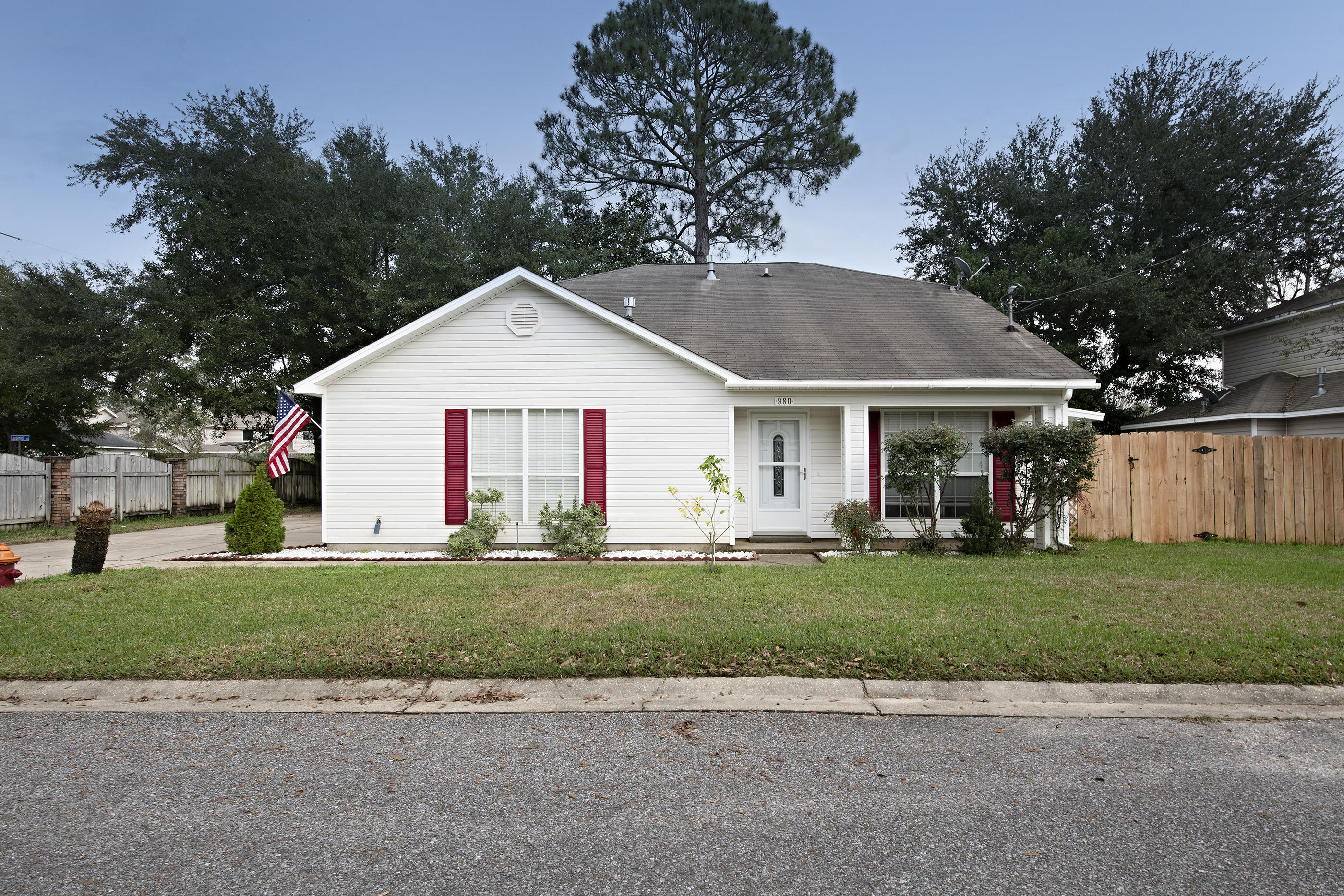 Wonderful home on a corner lot tucked away in the heart of Fort Walton Beach. As you pull into your driveway you will notice ample room for parking in addition to your 2-car garage. As you enter through the garage, you'll walk through your separate laundry room and into the hallway. From there, your large 1st floor master bedroom is to the left and your updated kitchen with stainless steel appliances and granite counter tops is to the right. As you enter the kitchen, you'll love the breakfast bar that opens into your living room with high vaulted ceilings. Take a quick step outside through your sliding glass doors from your living room onto your covered patio to enjoy those warm summer days. Outside, you'll also notice a custom motorcycle shed and storage shed with a concrete base. As you venture upstairs you'll notice 2 large bedrooms and another full bathroom. Schedule a showing for your future home today!