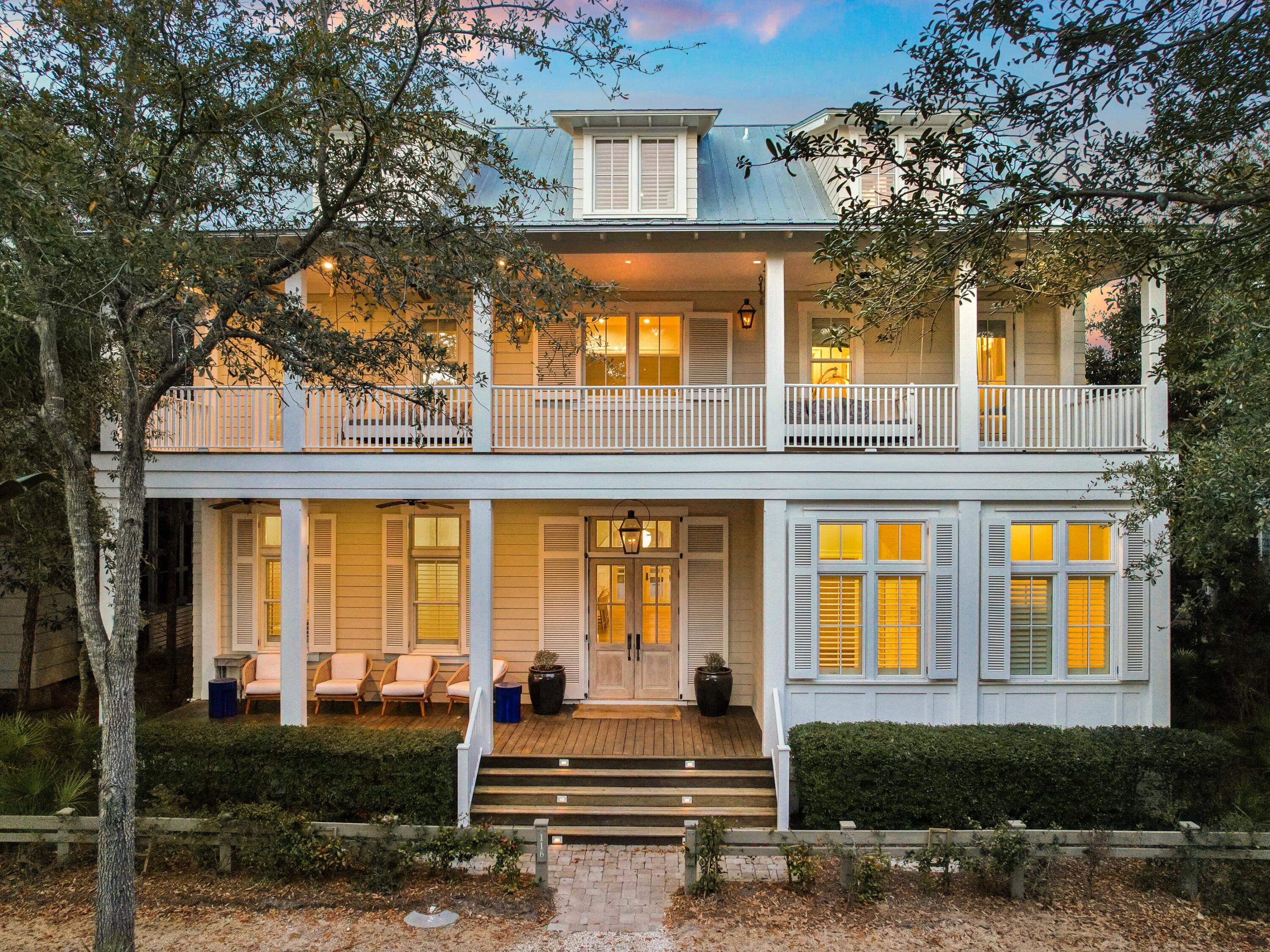 An extraordinary residence in the heart of WaterColor, 116 Wiregrass Way offers more than 5,500 square feet of thoughtfully designed living space with six bedrooms, six full bathrooms, one half bath, and a custom six-bed bunk room. A two-car garage, dedicated golf cart parking, additional guest parking, and a private elevator serving all levels add convenience and ease.
Positioned across from a wooded preserve, the home pairs timeless architectural character with modern upgrades designed for comfort, wellness, and effortless entertaining. Upon entry, an arched white Chicago brick foyer, antique oak beams, and a grand staircase introduce the residence's warm coastal elegance. The expansive main living area is anchored by a white brick fireplace and features antique whitewashed wood ceilings, custom millwork, and abundant natural light.
The chef's kitchen is designed for both daily living and entertaining, featuring dual islands, two dishwashers, Wolf and Sub-Zero appliances, a built-in Miele coffee system, and a newly refreshed island countertop. A new Wolf range and oven further enhance the kitchen's performance and functionality.
Significant infrastructure improvements elevate the home well beyond typical expectations. Two HVAC systems have recently been replaced and are complemented by three whole-home Air Scrubbers that enhance indoor air quality. A whole-house water treatment system, paired with an additional point-of-use filtration system, provides purified water throughout the residence.
Technology is seamlessly integrated with enterprise-grade Ubiquiti Wi-Fi delivering strong coverage throughout the home and outdoor spaces. A fully integrated Lutron lighting system allows every light to be controlled through custom scenes, wall keypads, or a mobile device. Sonos audio with six distinct zones provides immersive sound throughout the property. The home is also equipped with a Level 2 Ultium EV charger located on the parking pad.
The first level includes a junior primary suite with a king bed and walk-in closet, a private office, a spacious pantry, and a powder bath. Three sets of handcrafted cypress French doors open to a screened outdoor living room centered around a fireplace. The space features a generous dining area and summer kitchen with a Wolf grill, beverage refrigerator, sink, and ice maker, creating seamless indoor-outdoor living.
Beyond the porch, the private courtyard unfolds as a resort-style retreat with a swimming pool, spa, fountain feature, and multiple lounging areas designed for relaxation and entertaining.
The primary suite serves as a private sanctuary with vaulted beamed ceilings, a sitting area, breakfast bar, and private balcony overlooking the pool. The spa-inspired bath features marble finishes, a soaking tub, and a spacious walk-in closet. The second level also includes three additional guest suites, each with a private balcony and full bath, along with a well-appointed laundry room with custom cabinetry.
The third level provides additional flexibility with a guest suite, secondary living area, and a custom bunk room with six built-in bunks and a full bath, ideal for hosting family and guests.
Residents enjoy access to WaterColor's renowned amenities including six resort-style pools, the recently renovated gulf-front beach club, tennis facilities, a fitness center, scenic trails, the BoatHouse for paddleboarding and kayaking, and Camp WaterColor's lazy river and recreation areas. Set within 499 acres along South Walton's celebrated coastline, 116 Wiregrass Way offers an exceptional opportunity to experience luxury coastal living along 30A.