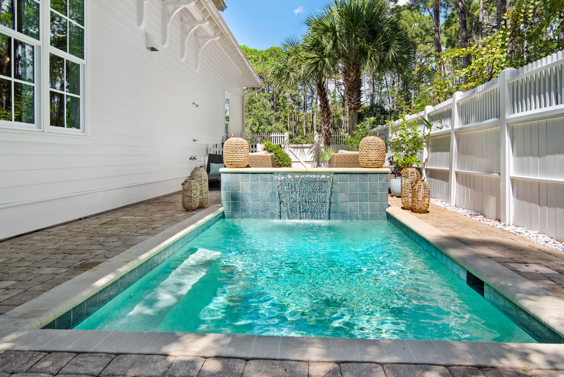 Welcome to 58 Harvest Moon Lane, a thoughtfully designed pool home tucked within the gates of Watersound West Beach—one of 30A's most coveted communities. Perfectly positioned on preserved green space, this beautifully maintained residence offers a peaceful setting adjacent to the boardwalk to the beach and community pool.  Offering 4 bedrooms, 4.5 baths and over 2,700 square feet of living space, this home is ideal for both full-time living and vacation enjoyment.

The open-concept layout features hardwood floors, 10-foot ceilings, and abundant natural light throughout. The spacious living and dining areas seamlessly connect to a well-appointed kitchen with stainless steel appliances, marble countertops, and a large center island—perfect for everyday living and entertaining alike. The first-floor primary suite includes a generous walk-in closet and  en suite bath with dual vanities and shower. Upstairs, you'll find another master suite with soaking tub and separate shower, two guest bedrooms with en suite baths, and a second living area with cathedral ceilings, offering flexible space for family and guests.

Enjoy evenings on the screened porch with gas fireplace overlooking the preserve area or take a dip in the private POOL featuring a relaxing fountain wall and generous outdoor living area. There is plenty of parking with a single car garage, space for at least 3 cars in the driveway, and 2 parking spaces across the street. This setting is "one of a kind" in Watersound West Beach and lot is one of the most secluded of the larger homesites in the neighborhood. Home is being offered furnished with exclusions. 

Watersound West Beach features a community pool/clubhouse, putting green, boardwalks and trails, green spaces and parks, boardwalk to the beach with bike parking, security gate, high speed fiber optic internet, and fitness center at Watersound Beach. The beach access through Deer Lake State Park is a perpetual easement so no customary use worries here! And no crowds!  Whether you're seeking a primary residence, second home, or investment opportunity, this home offers the ideal blend of comfort, privacy, and beachside charm.