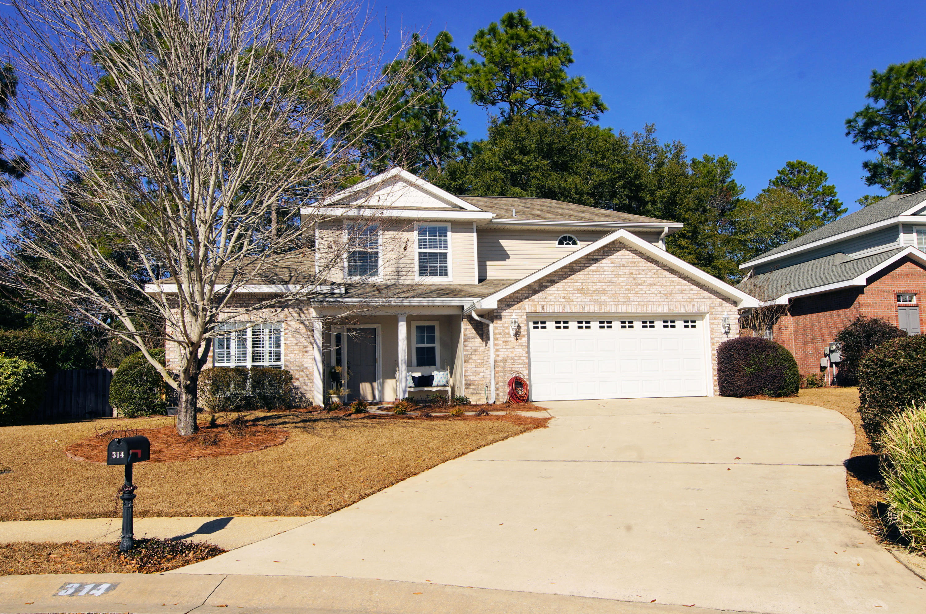 Pristine Contemporary Four Bedroom, 3 bath brick home in Desirable Woodridge neighborhood. Enter covered porch and find a dining room/office to the left and a large open living room straight ahead with a fireplace on the diagonal. Windows have custom shutters or blinds. Transom windows add extra natural light. Kitchen features breakfast bar, eat-in area, stainless appliances and granite counters. Home has been freshly painted and diagonal tile floor looks as fresh as when installed. First Floor large Master with adjoining master bath featuring jetted tub, dual vanities and separate shower. Stairs lead to 3 upstairs bedrooms; Two have new carpet. Third bedroom, stairs and landing have hand scraped manufactured wood flooring. 2014 Carrier HVAC with 2 zones and WiFi. Covered back patio.