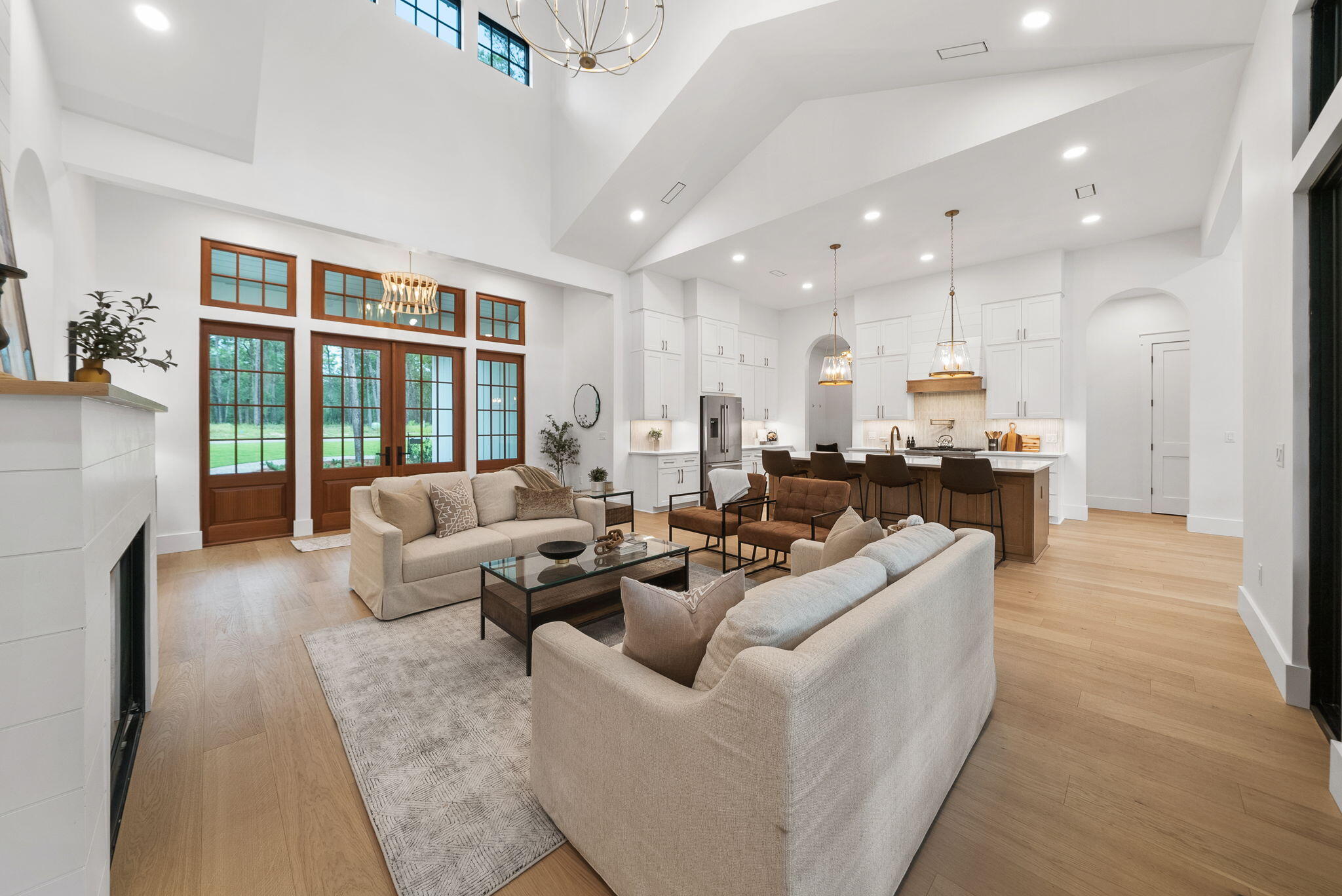This stunning NEW CONSTRUCTION, single level home in Wild Heron is where modern craftsman design meets resort-style living. Welcome to a home where timeless design and modern luxury meet coastal serenity—just minutes from 30A and nestled within the gates of Wild Heron, one of Panama City Beach's most desired, fast growing communities on the shores of Lake Powell.

Thoughtfully designed and construction just completed, this highly desirable, single-level masterpiece spans 3,300 square feet under roof and offers 2,401 square feet of interior living and over situated on a generous .37-acre homesite that backs up to conservation area offering both privacy and peaceful views. From the moment you step through the 8' solid Mahogany French doors, you're greeted by a sense of understated luxury. As you enter, you're greeted by a showstopping 24' cathedral vaulted ceiling in the living room, 12' ceilings flowing throughout, and an open concept anchored by a natural gas fireplace. Arched doorways add architectural charm and warmth, while modern, black Andersen windows and French doors to the patio flood the space with natural light. Step outside the living area to your private oasis where you'll find your own private, saltwater pool surrounded by a pavered deck, lush landscaping, and a vaulted, covered back porch plumbed for an outdoor kitchen. 

The open-concept layout is both inviting and functional, perfect for effortless entertaining and everyday living. Enjoy white oak flooring throughout, along with a curated palette of classic tile selections in the bathrooms, mudroom, and a timeless black-and-white checkered tile mud room and butlers pantry. 

The kitchen is timeless and classic featuring white shaker custom cabinetry on the perimeter with a warm white oak wood island, Quartz countertops, and a full suite of Bosch appliances, seamlessly blending style and utility. A spacious butler's pantry off the mudroom and kitchen adds even more prep space with built-in shelving, generous counters, and a beverage fridge. 

The primary suite is a true retreat with stunning conservation area views, shiplap clad vaulted ceilings, a spa-like primary bath with a soaking tub, zero-entry tiled shower, and a custom walk-in closet with double vanities paired with modern tile selections. With four bedrooms and three baths, this home offers a split floor plan that prioritizes privacy and comfort. All bedrooms offer walk-in closets, three bedrooms of the four bedrooms feature vaulted ceilings and a generous size Jack n' Jill bath with separate vanity areas allow for the best use of the third bathroom. 

The 2-car garage offers tall ceilings for expanded storage and an EV-car charger for convenience of those with electric vehicles or golf carts. Crafted with enduring materials, brick and Hardie siding, this home captures the charm of classic craftsman style with the function and efficiency of modern construction with a coastal elegant twist. 

Spanning 734 pristine acres along the shores of Lake Powell, Florida's largest coastal dune lake, this extraordinary community invites residents to slow down, breathe deeply, and savor the beauty that surrounds them. Morning strolls along miles of tree-lined walking trails, afternoons spent lounging at the resort-style lakefront pool, and evenings by the boathouse pavilion watching the sun set over the water, this is the rhythm of life here. With access to a community dock, fitness center, playground, and the opportunity to lease private boat slips with power lifts, Wild Heron was built for those who crave both adventure and serenity. 

For those seeking the ultimate in exclusivity, Watersound Club membership elevates the experience with multiple private Club opportunities. In Wild Heron, enjoy the challenge of Shark's Tooth Golf Club, a Greg Norman-designed 18-hole masterpiece. Unwind at the clubhouse, sharpen your swing at the driving range, or hit the courts for a game of tennis.