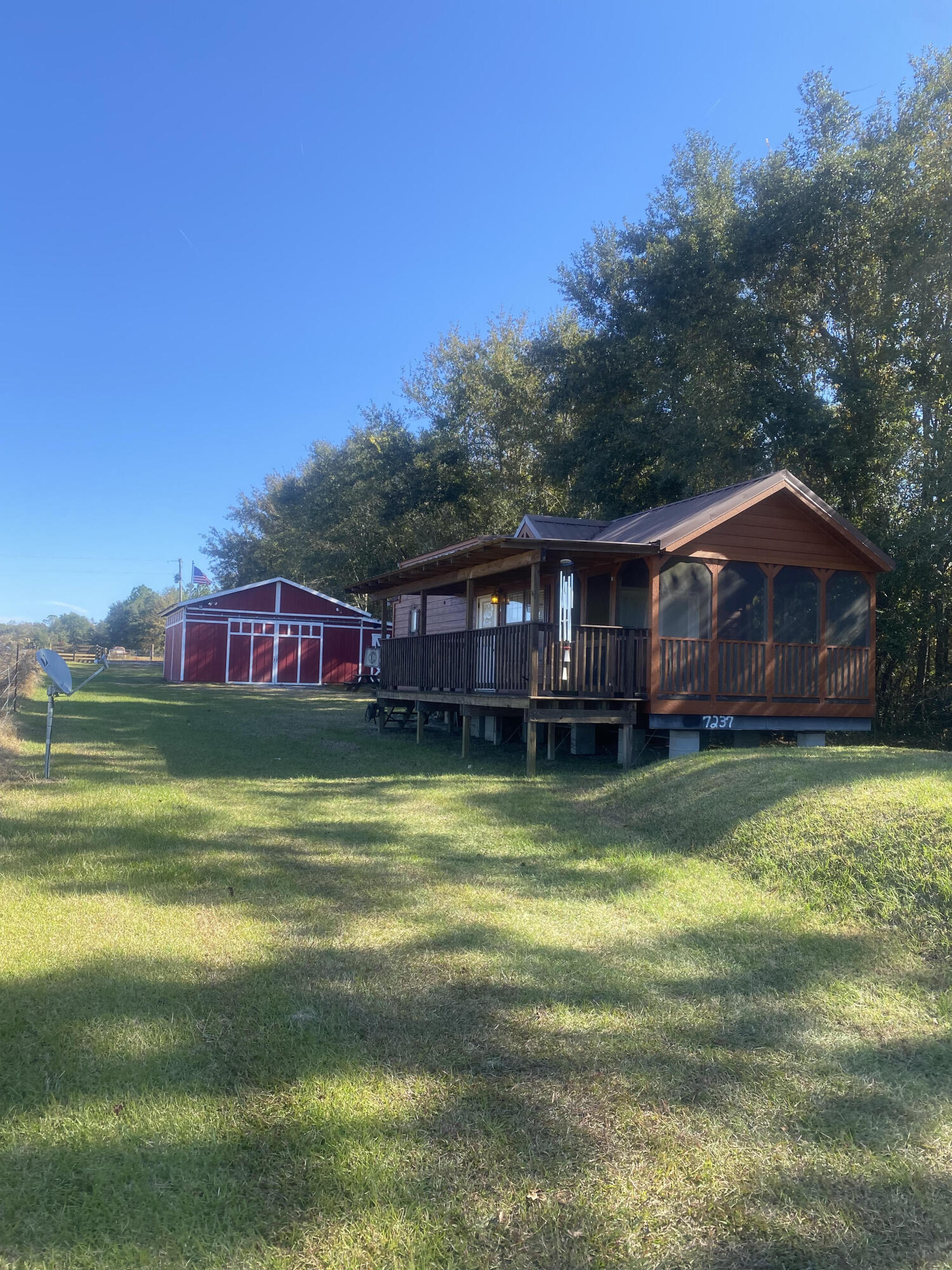 This is is the getaway you've been waiting for! 102 acres in North Walton County with a tiny home, also referred to as a Cabin on Wheels, and barn. The cabin is built by Stone Canyon Homes in Brilliant, AL. It is the Echoe Model. Find more information at stonecanyonhomes.com.  The barn has several separate storage areas, bathroom and bar area. Well, power and septic already in place. 
The majority of the property is mature hard woods with several trails cleared throughout for hunting, as well as beautiful home sites, if building was your goal.
 This is a must see to appreciate!
Floor plan of cabin in Documents.