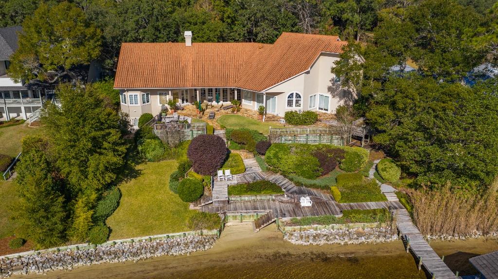 MAGNIFICANT waterfront estate located on a .83 acre lot with 150' on picturesque Rocky Bayou!! This home was architecturally designed to offer AMAZING Bayou views from almost every room while allowing for an abundance of natural lighting. This masonry stucco home was upgraded with a stone coated metal roof in 2014 and 2 Trane HVAC systems in 2019. The open floorplan allows for an abundance of natural light and features multiple living areas, formal dining room, chefs kitchen, master suite, gym, office/library and an additional bedroom suite downstairs and two additional bedroom suites upstairs. Home upgrades include a solid cherry entry door, Pella windows and exterior doors, marble and granite foyer, oak, birch and stone tile floors, high ceilings, deep baseboards, extensive millwork, office built ins, cased windows and doors. The chefs kitchen features an upgraded appliance package, a butlers pantry with a wine refrigerator and ice maker, two separate pantry's, cherry cabinets and granite counters. The master suite offers a private sitting area, two large closets and two complete baths...one with a steam shower and the other with a garden tub! There is also a door leading from the master bath to a private patio with a hot tub! The exterior of this home offers a private electronic entry gate, paver driveway leading to a 3-car garage, extensive landscaping, flagstone walkways, covered patio, multi-level decking, seawall, covered boat dock with a lift and a 24 zone sprinkler system to irrigate everything. There is also a workshop/hobby room in a tucked away basement accessible from the back yard. This amazing home has so much to offer and cannot be duplicated at this price!!