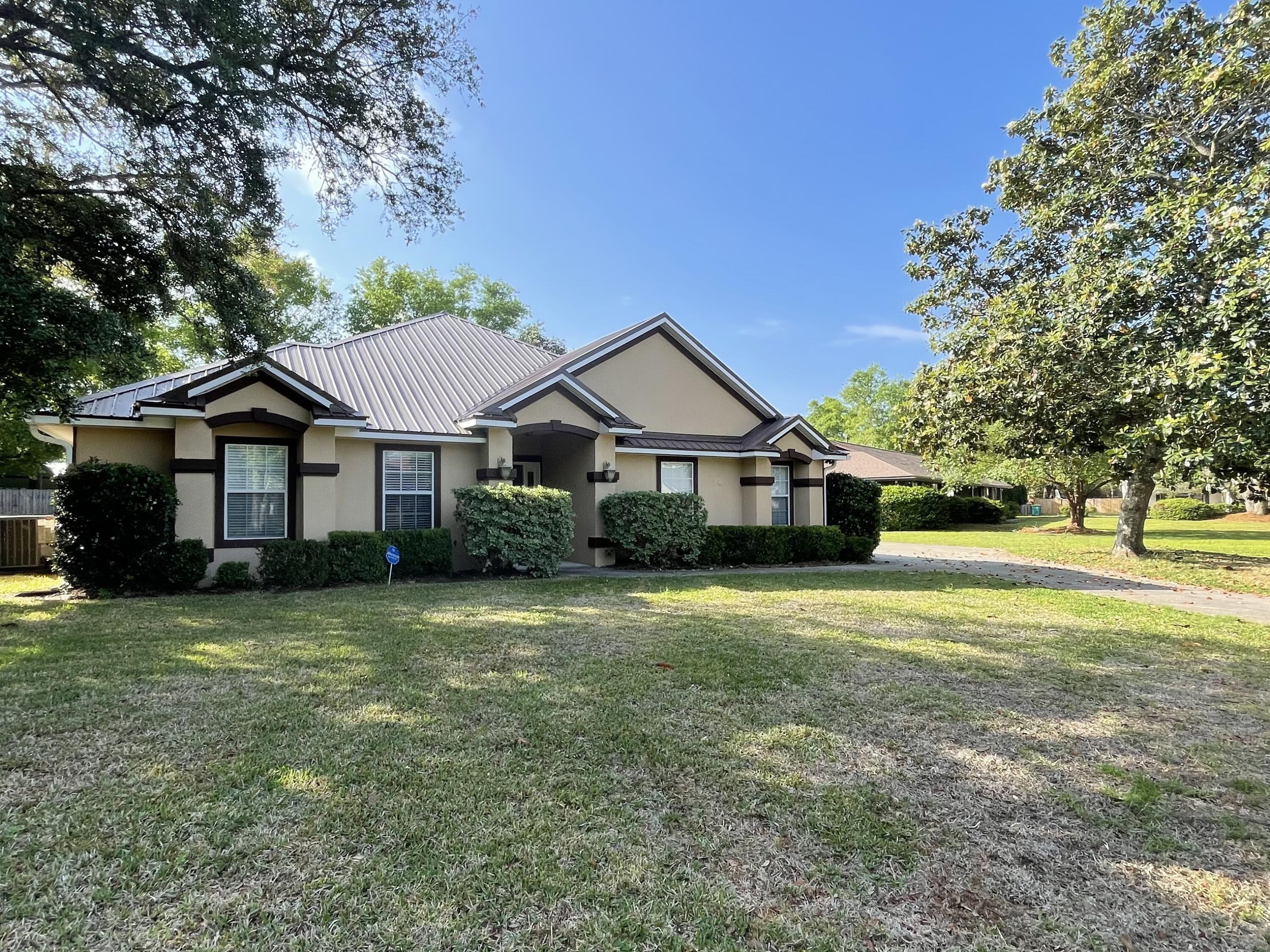 Super rare 4 bedroom, 2.5 bath home in the most desirable neighborhood, in the most desirable school district in the state of Florida! As you approach this Mediterranean Style home you will notice the extra large expanded driveway leading to the two car garage on the side of home. This lovely home has been updated to include energy efficient hot water heater, air conditioner, and foam insulation, as well as ceramic tile throughout with attention to detail. House features split bedroom floor plan and high ceilings. Bose 7.1 surround sound system already in place. All updated lighting fixtures and ceiling fans throughout. Crown molding and built in plant shelves. In the kitchen you will find high-end stainless steel appliances surrounded by pecan cabinets for that nice added touch. .  A corner fireplace in the family area is surrounded by custom woodwork and ceramic tile. The master suite has a tray ceiling with french doors leading outside. Double closets lead to the master bath which features a whirlpool cultured marble garden tub, and separate tiled shower.   Large fenced back yard features an elevated deck as well a huge storage shed. Call to see today, this home.