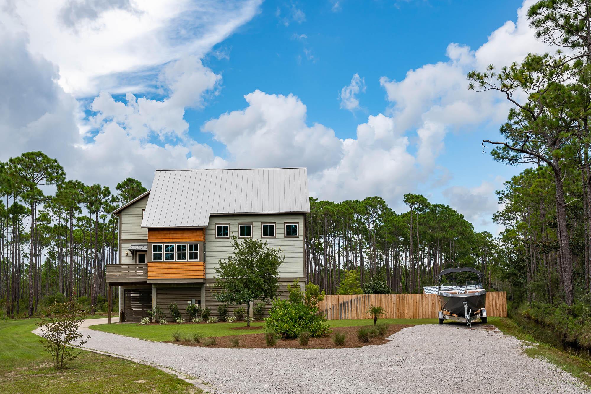 This chic, modern farmhouse located  on TEN acres is designed by famed architect David Sargent. The home was designed with large open spaces, high ceilings and wide gallery halls, mixing modern with complete comfort. This four bedroom, four bath private sanctuary offers two living areas and office space. Interior features include a stunning chefs kitchen, custom cabinets and stainless steel appliances, covered parking for seven, plus one golf cart, well, sprinkler system, Schwinco Impact Turtle glass windows, two AC systems, integrated house de/humdifier, built in vac system, gas stove and BBQ, all spray foam insulation, hardwood throughout, all LED bulbs, ethernet and built in surround sound Bose speakers. Complete charm with two sets of antique gates from the 1400's and 1800's that leads you into the quaintly landscaped patio. The property allows for horses, 30amp RV power hook up and is close to the Charles E Cessna Landing Park with bay access. Property has been split with second five acres a buildable site for investment opportunity. (PLEASE note that approx 80% of land is CONSERVATION USE). Buyer to verify all dimensions and buildable area.