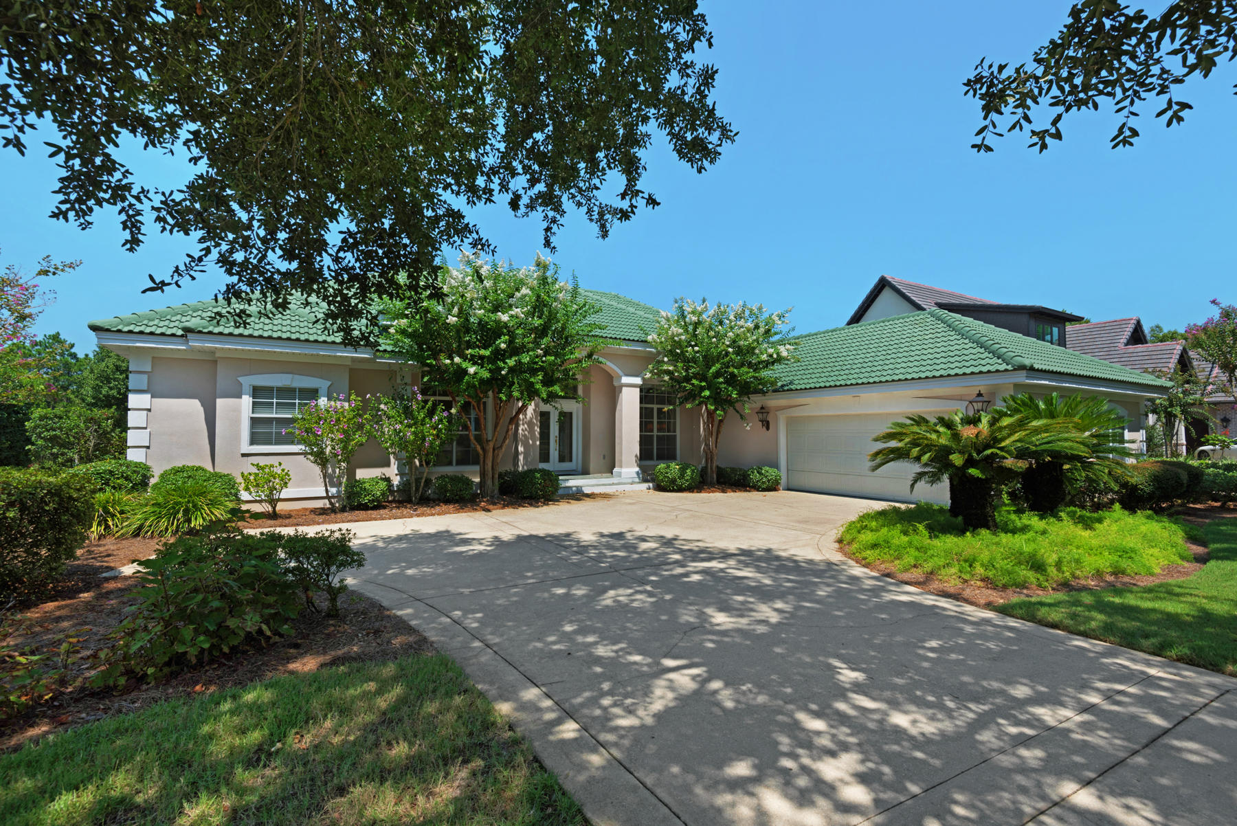 This home epitomizes the #1 rule in real estate: location, location, location. Tucked away at the end of an enchanting lake enclave in Destin's highly desirable golf community Regatta Bay, this might be one of the best interior lots in the neighborhood. It's exceptionally quiet, offers gorgeous scenic views, and gazes west across the lake for the best sunsets. Lake views are visible from all main areas including the kitchen and master suite and are emphasized by large windows and sliding glass doors. With some updating, this beautifully landscaped, one-level, 2,704 sq ft, Mediterranean-style home will be a fresh and current lakefront retreat. Features include: high 12-foot ceilings, a well-configured kitchen design, ceramic tile floors, a dedicated office, fireplace, and screened-in porch. The master suite is quite sizable and features sought-after amenities like double closets, separate high counter sinks, jetted tub, and walk-in shower with double showerheads. Home also includes a speaker system, central vac, 2-car garage, and room for a pool. The Regatta Bay lifestyle offers access to an acclaimed 6,894-yard golf course, golf club with dining, 2 tennis courts, and playground. The beach, Destin Commons, Whole Foods, LuLu's, and the boat marina are just a short golf cart ride away. This gated community also includes pickle ball courts.