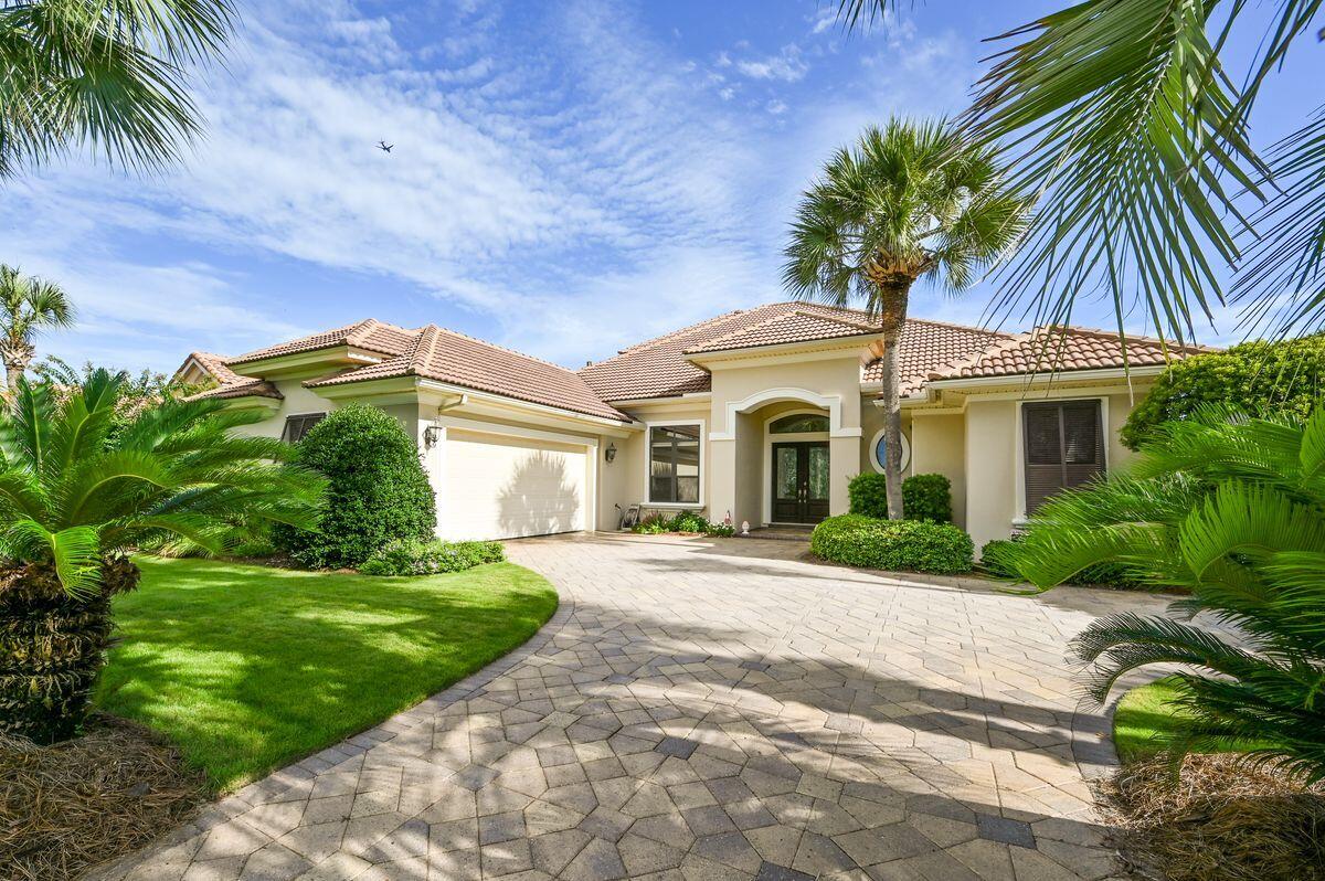Welcome to this beautiful golf course home located in the gated community of highly sought-after Regatta Bay. Nestled on the 4th fairway, it enjoys a panoramic view of the course and a 63-acre nature preserve. 
As you enter the grand foyer through the double leaded glass mahogany doors, you are greeted by soaring 12' ceilings, extensive moldings, indirect lighting, and gleaming tile floors. The formal dining room boasts columned archways and a special display cabinet with a mirrored buffet. The formal living room provides the warmth of a ventless gas fireplace and a wall of sliding glass doors that lead to the spacious lanai and private pool area. 
The gourmet kitchen is a Chef's delight, featuring custom Arizona Alderwood cabinets, granite countertops, double ovens, double microwaves,