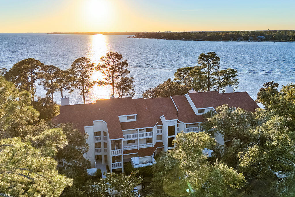 Bayfront Beauty! Stunning views from this 1BR/1BA condo at Bay Villas at the Bluewater Bay Marina, with an additional large loft area plus an office space. As you walk into this 1,280SF condo, you are greeted with serene bayfront views from almost every room. The kitchen features quality Thomasville solid wood craftsman cabinetry with 42-inch tall uppers and dovetai drawers, granite countertops, updated appliances walk-in pantry, and laundry closet with washer and dryer that convey. As you enter the living space it is open with soaring 20 ft ceilings, fireplace, & large private balcony access with breath-taking serene bay views - this unit truly is one of a kind! The bedroom could be utilized as additional living room/flex space and has private access to the balcony. Upstairs is large private loft area, which overlooks the living space below, and may be utilized as an additional sleeping loft/flex space. The condo has the capacity to sleep 6+. Other features include a large bathroom with jetted tub, along with al private office space. This darling unit also has a private oversized garage (lease option grandfathered to the unit). Freshly renovated with all new paint and smoothed ceilings, the unit is professionally cleaned and in immaculate condition. Perfect as a full-time residence, second-home/vacation spot, or as a lucrative short-term rental which would be perfect for AirBNB/VBRO or mid-term rental for investors. This is the best-priced bayfront condo here in the Bluewater Bay area! Located just a short walk from the Marina and Schooners Restaurant & Bar, and all the amenities of world-class Bluewater Bay where golfing, tennis, pickleball, pools, retail, medical offices, restaurants, and top-rated schools are all part of the perfect lifestyle, and all within 15 minutes reach of Eglin AFB or Destin and its beautiful white sandy beaches and emerald waters. The condo is professionally deep cleaned, freshly painted throughout, and ready to go! Don't miss this rare bayfront opportunity which also allows short-term rentals!