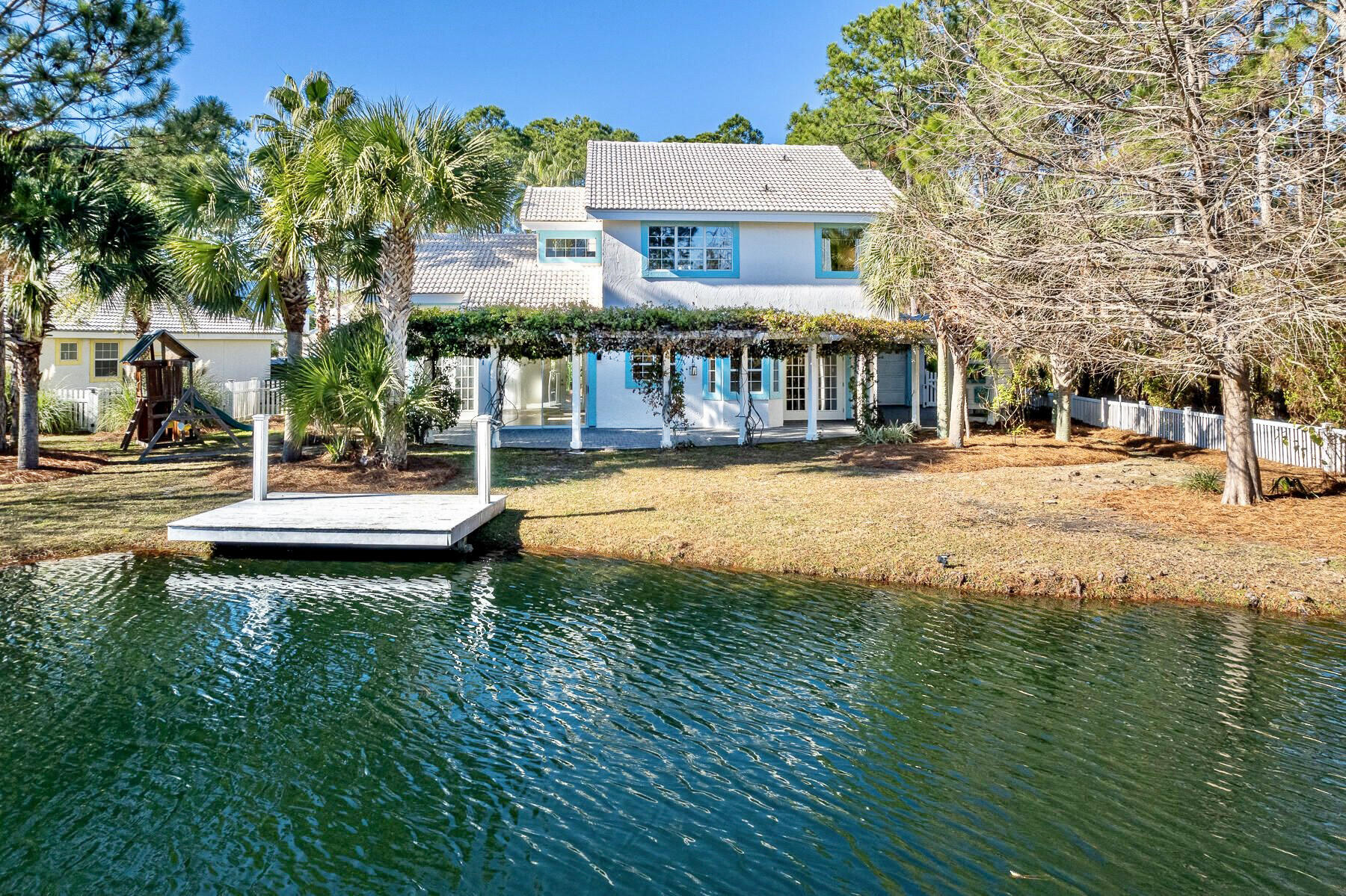 Welcome to La Vie À La Mer, a charming, 3-bedroom, 3-bathroom lakefront retreat in Seagrove Beach, Florida. Situated less than half a mile from the beach & the Gulf of Mexico, and just off 30A, this home perfectly balances serenity with convenience. As you enter the home, you are welcomed by beautiful lake views and your own private dock. The home's large windows and French doors flood the space with natural light, highlighting the thoughtfully chosen furnishings and decor. The cedar shingle feature wall and wood-burning fireplace create a warm, inviting atmosphere ideal for unwinding.
With the Gulf of Mexico just a short stroll away, you'll appreciate the easy access to the beach, with a public access located at the end of your street. The home provides ample space for relaxation and recreation, both indoors and out. Besides the main living areas, you'll find two versatile flex spaces that can serve as a home office, studio, bunk room, or gym. The garage, heated and cooled, can be transformed into a workshop or additional living area. 

Outside, enjoy the expansive back patio and yard, complete with your own private dock overlooking the serene lake. Nestled in the tranquil, gated community of Somerset Bridge, this home offers a rare blend of a quiet retreat and vibrant coastal life.
Explore the nearby shopping and dining options in Seaside and Seagrove, catch a sunset on the beach, or wander the trails of Point Washington State Forest, accessible right from the neighborhood. La Vie À La Mer is your gateway to experiencing the best of Seagrove Beach. 

Offered fully furnished and turnkey ready, this home is an exceptional choice whether you're seeking a primary residence, a second home, or a vacation getaway. Don't miss your chance to own this dream property and start enjoying life on 30A!
