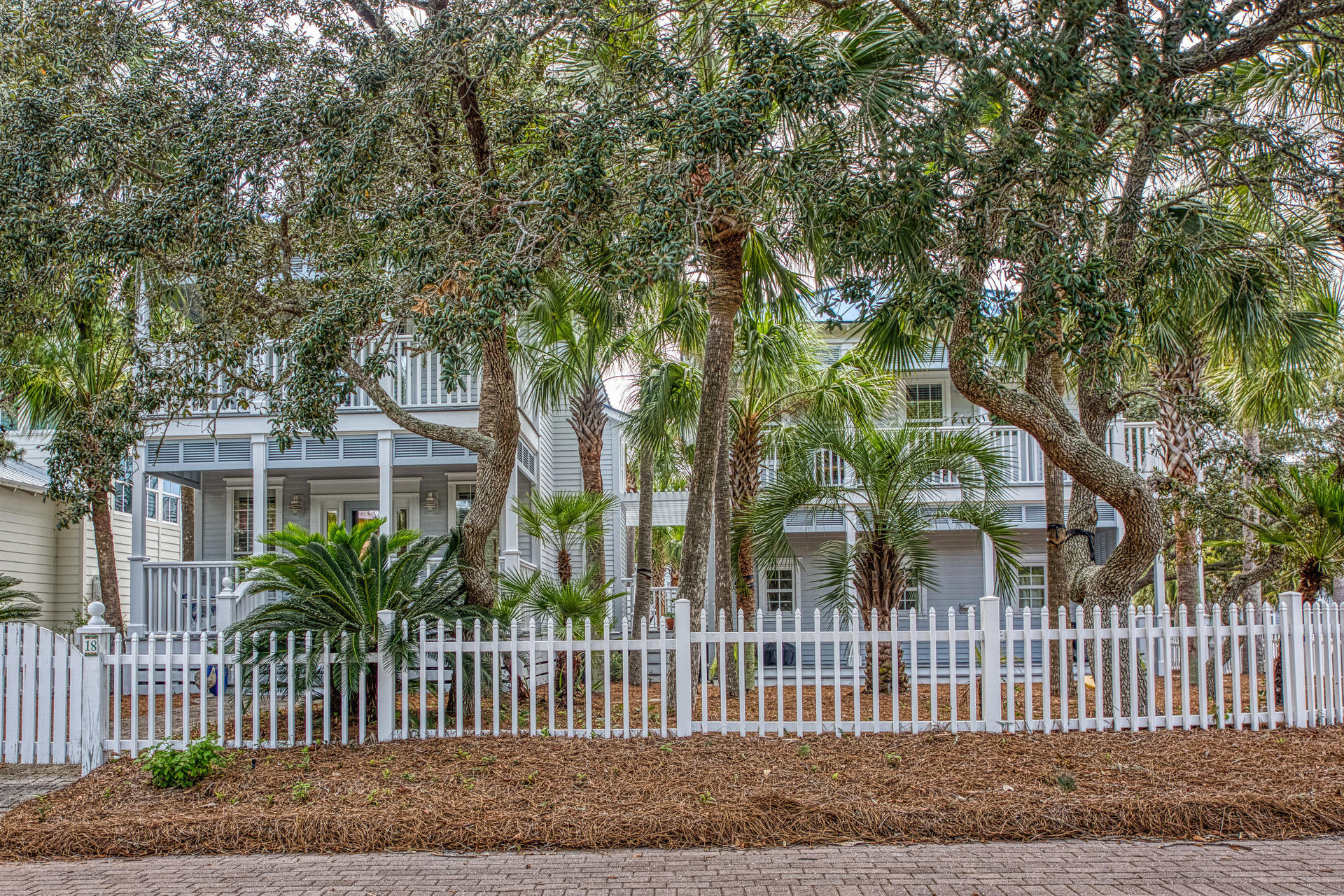 Great home in the gated Old Florida Beach Neighborhood. Extra large corner lot beautifully landscaped. You can enjoy the tropical paradise from one of the seven porches as you admire the 28 palm trees and listen to the surf. The main house features three bedrooms and three full baths. Enjoy the gulf view from the master bedroom balcony! There are several new updates: Kitchen, first floor flooring, tank-less water heater, gas fireplace, washing machine, exterior paint job (spring 2020), and newer AC units. Additionally, there is a two bedroom/two bath guest house that includes a full kitchen and brand new washer/dryer. There is also a newly finished bonus room with a half bath, the opportunities with this space are endless. This entire property could be a residence, a rental, or both. Just a short walk to the community pool and the neighborhood dock on Draper Lake, 300 steps to the white sand via the neighborhood boardwalk. Ice cream, "Local Catch", "Goatfeathers", "Basmatis", and "Gulf Place" a short stroll or bike ride away.