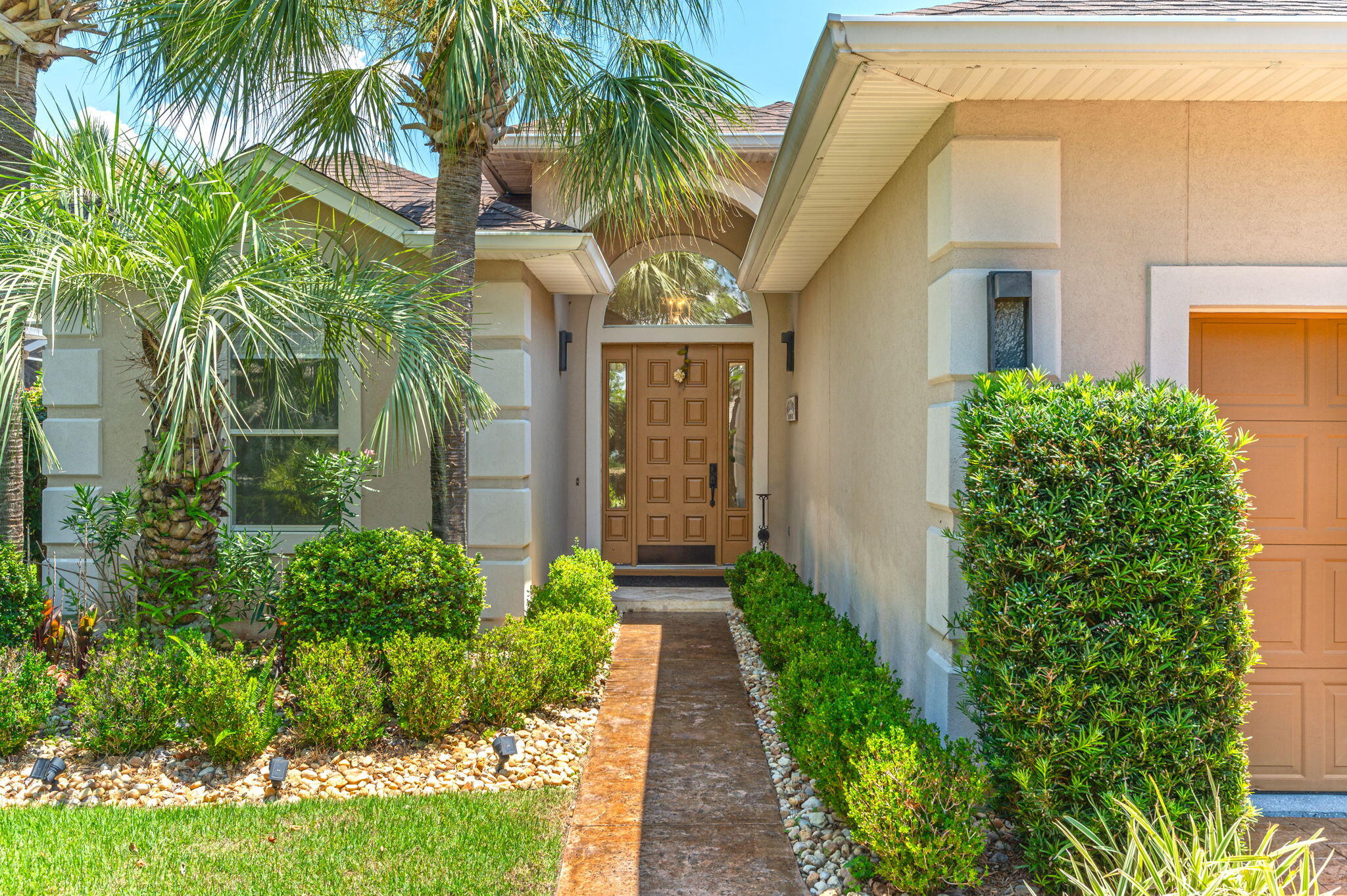 Come see this beautifully updated custom built lakefront home in the private gated community of Emerald Lakes. You'll find travertine flooring throughout and a unique floorplan with a 3 way split bedroom design and 3 FULL baths. As you enter, the majestic columns draw your eye to the 10 and 12 ft. ceilings. You'll notice many architectural details in this transitional mediterranean modern design that add character to the home such as the beautiful tile and woodwork surrounding the fireplace and the large windows in the living room that give it a bright and airy feel. Enjoy both a formal dining space as well as an eat-in kitchen with gorgeous lake views, granite countertops, penny tile backsplash and stainless steel appliances including a wine cooler and warm wood accents such as open shelving and a beamed ceiling. You can also access the screened side porch to enjoy your morning cup of coffee listening to the soothing fountain and enjoying lake views amid your own tropical paradise. The huge master suite offers a sitting area with windows framing the lake and fountain. You'll love the adjoining master bath complete with a beautiful tiled shower, whirlpool tub and walk-in closet. This unique one of a kind property has been impeccably renovated with an abundance of upgrades including a custom glazed faux finished stamped concrete screened porch, patio and driveway, is wired for a whole house and exterior surround sound system, and a sprinkler system (well) with feeders, drip heads for flower beds and potted plants. The 2 car garage with epoxy finished floor leads into the laundry room complete with washer and dryer. The amenities of Emerald Lakes include a premier community pool, fabulous playground, tennis and basketball courts. Roof was replaced in 2021 and HVAC is 2015. Come take a look at this gorgeous home in a premier Destin location today!