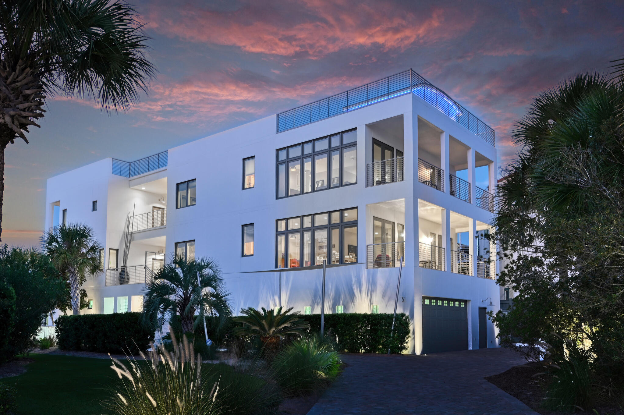 South of Hwy 30A, in the small, gated seven home community of Seawinds, this property's appeal is immediately appreciated by its spectacular contemporary architecture! Constructed by Artisan Builders in 2002 and kept in excellent condition by only two owners and never rented. This concrete and steel constructed lake-front home located 500' from the public beach access and situated between two rare Coastal Dune lakes has amazing views of the emerald green waters and sugar white sands of the Gulf. This superior construction with impact-resistant windows covered with Mylar has less maintenance and offers greater protection during severe weather such as hurricanes, high winds and heavy rain. Although this is a single-family residence, there are four separate living areas, each of which offer gorgeous views of the Emerald Coast. All floors may be accessed by the home's elevator. The first floor features an oversized five-car garage, a workshop/storage area, a bonus room opening to the renovated saltwater heated pool with sail shade, spa, outdoor fireplace, twin outdoor showers, a half bath, custom landscaping, and fencing. It is a backyard resort overlooking the beautiful lake with a dock for fishing and watching wildlife. The second and third levels each feature a master suite with superb gulf views and large balconies. Both living areas have fully equipped kitchens, office/bonus room/additional bedroom, a half bath, plus the master suites have two walk-in closets and en suite baths with double sinks, a jetted tub, tile shower, and attractive fixtures. The main kitchens have Sub-Zero refrigerators, gas cook tops, dishwashers, trash compactors, double sinks, granite countertops, and walk-in pantries. Across the breezeway from the second-floor master suite is a one-bedroom guest suite with a kitchenette, full bath, and balcony with beautiful views of the coastal dune lake. Across the breezeway from the third-floor master suite is a two bedroom/two bath guest suite with cozy living area and kitchen essentials. Each bedroom has balcony access overlooking the lake. Freshly painted inside and out, this home has five bedrooms, two offices/additional bedrooms, five full baths, and three half baths. The clean lines, artistic fixtures, contemporary style, abundant natural light and great views enhance the design so that the home is just as appealing inside as the setting is outside. The fourth level, a +/-2,800 sf roof top deck is ideal for entertaining, sunbathing, and sunset watching. The roof top has a heated/cooled bonus room which allows for enjoyment of the 360-degree views year-round. With amazing gulf and lake views from every angle, it is perfect for parties, exercise space, creative endeavors, or as just a beautiful quiet hideaway. The views from the rooftop deck during your fourth of July party allows your family and friends to see fireworks from Panama City to Destin.  Upon closing, seller would like, with buyer's acceptance, to lease back and occupy the property until December 20, 2022.  This home has everything you could ask for in a beach retreat. Make this one-of-a-kind gulf-view dream home yours today!