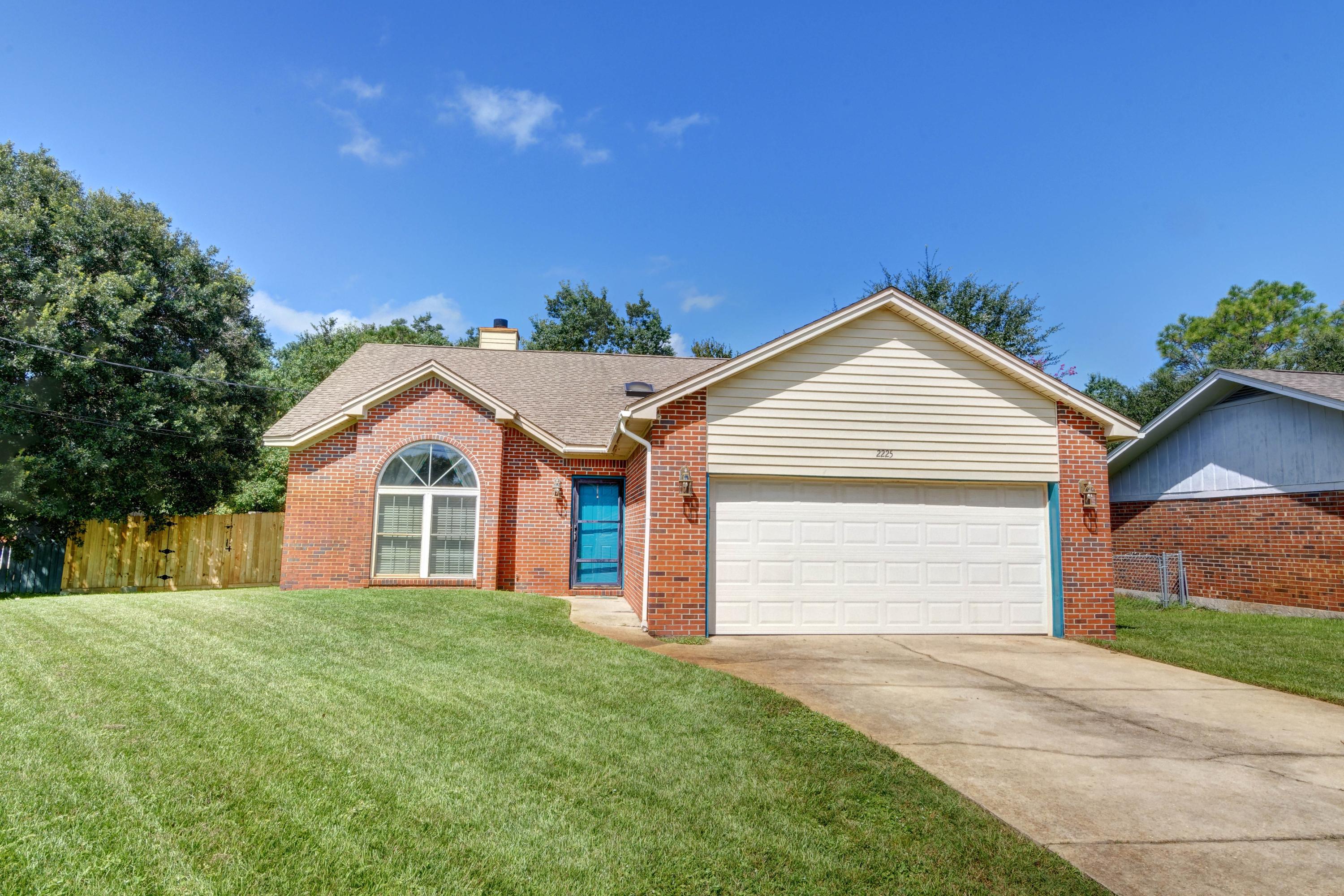 Welcome home to this serene east Navarre setting where you'll find an adorable and affordable all brick 3 bedroom/2 bath home on a half acre lot! Making this home and location even more unique is that it includes lake ownership (see survey), so feel free to manicure the current natural setting back and enjoy the view from your raised backyard deck and cabana that conveys! Walk up the drive and admire the well maintained yard and inside immediately appreciate the vaulted beamed ceilings in the living room and kitchen, as well as the two sided fireplace! Hard surface flooring extends throughout! With large windows and natural sunlight pouring in, you'll love cooking in your kitchen with plenty of room for the entire family to enjoy sitting down together! The master bedroom features a vaulted ceiling with a walk in closet, as well as double vanities and a jacuzzi garden tub/shower combo in the bathroom. The other two nice sized bedrooms also conveniently share a bathroom that has double vanities! The laundry room is located in the two car garage, but in the backyard is where you'll fall in love and have plenty of room to park a boat, RV, put in a pool, or just play! Enjoy a spacious and quiet backyard retreat with a unique shaped lot featuring an outdoor storage building, and a tucked away cabana, and you'll never want to leave. With a short commute to Hurlburt Field and only 4 miles from beautiful Navarre Beach, you will not want to delay on making this gem your new home!