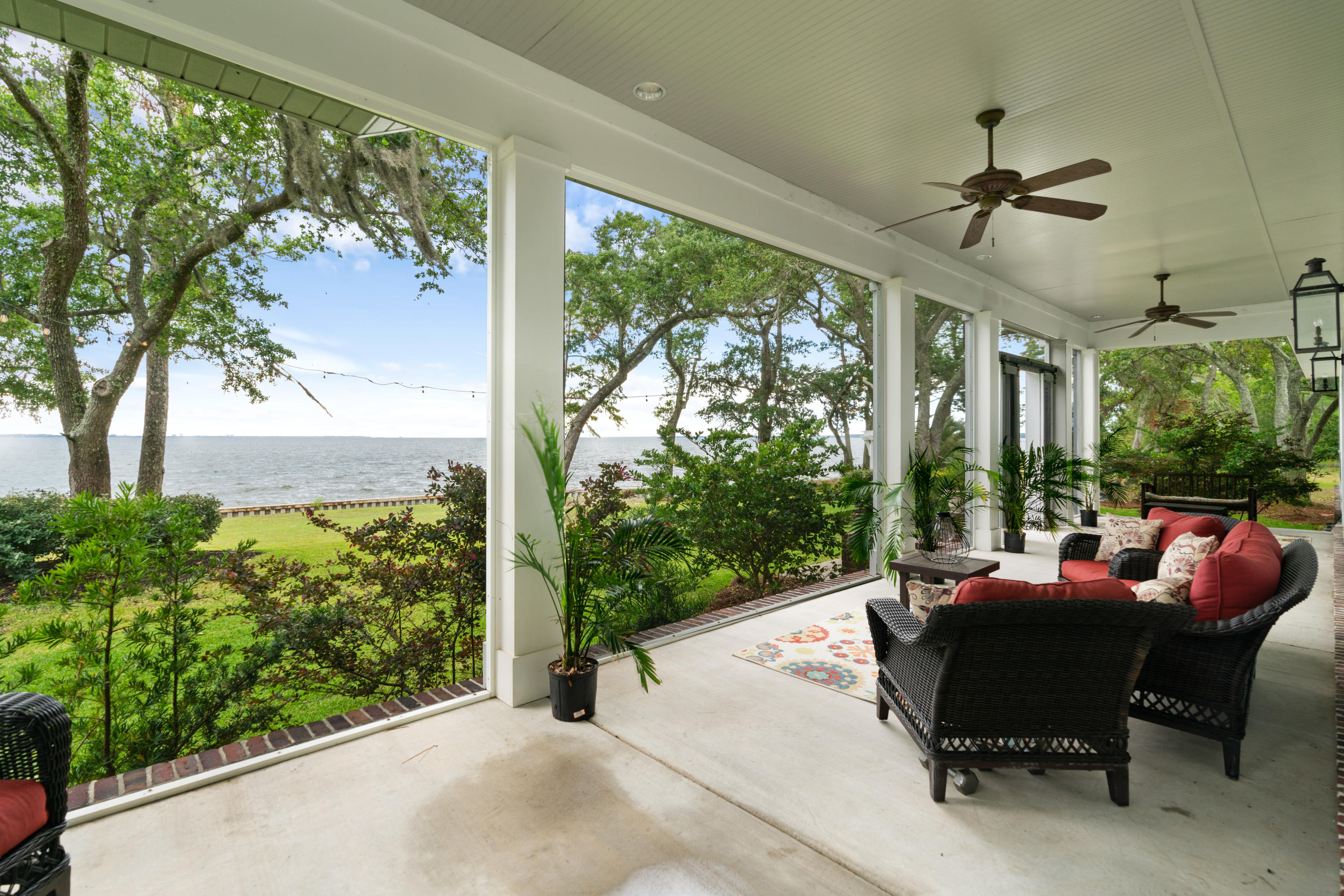 Custom built home under a canopy of live oaks on 138' of Bay front property with sweeping views and sunsets for days is the perfect place for your family. This 3 bedroom plus guest room/office and 2.5 baths, open floorplan has Bay views from the kitchen, living and master bedroom & bath! The family kitchen with oversized island, Jenn Air appliance package and walk-in pantry opens to the living room and dining room that seats 8 comfortably. Even the four-legged family members have a custom crate area in the mudroom! The screened-in porch with floor to ceiling unobstructed Bay views lead to the spacious backyard with firepit & grilling area. Too many details list, a few are concrete stained floors, metal roof, deep well irrigation, custom lighting, 800 sq ft Shop and seawall in place.