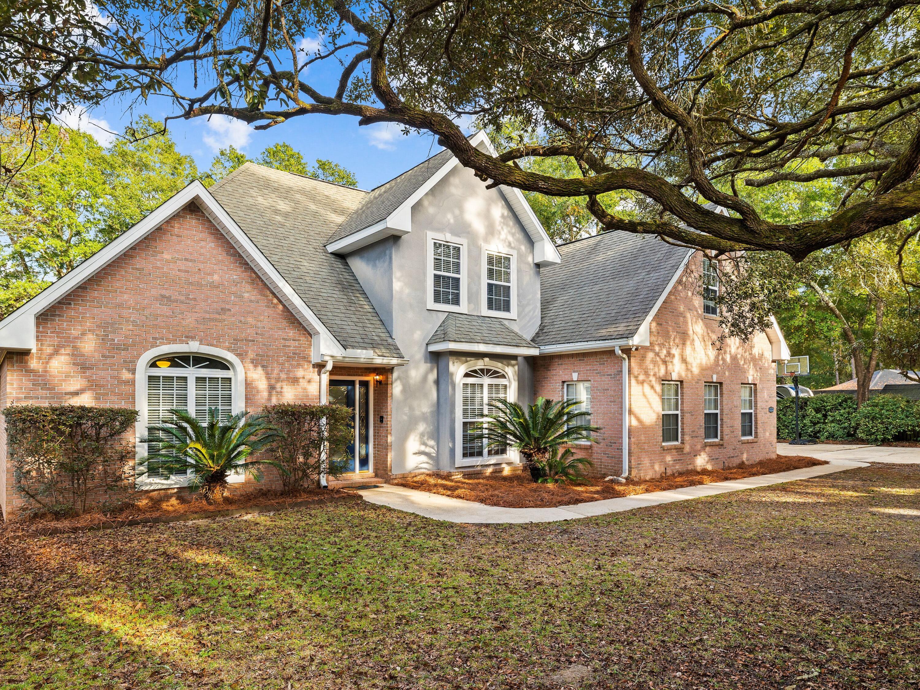 Sitting on a generous 0.76-acre wooded lot with no HOA fees, this spacious home is
enviably located backing onto a natural creek. It's conveniently close to a boat launch, making it very attractive for boaters, nature lovers, kayakers and fishing enthusiasts. The brick-built home has plenty of curb appeal, set in a mature oak grove and exuding a sense of privacy and exclusivity. A wide driveway leads to the side-loading garage and a sweeping path delivers you to the covered front door. Inside, five beds and three baths are complemented by a spacious living room, bright bonus/play room and a
formal dining/breakfast area. The adjoining kitchen is sure to be the social hub of the
home with a breakfast bar, solid surface countertops, custom cabinets and a useful pantry space. An oversized laundry features more storage and a built-in ironing board. The first-floor bedroom provides stair-free living, if required. The second floor has
more guest beds, a bonus area and a master suite with deep soaker tub. For keen hobbyists, there's a double garage and a detached 30' x 30' workshop along with space to store your boat beneath the car port. A new roof and new flooring throughout
the home make this an irresistible deal. With a fenced yard for imaginative play and a fish cleaning room behind the workshop, this private retreat certainly has it all.