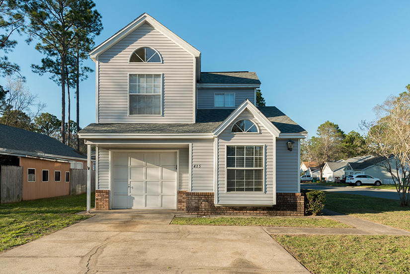 Cute central Fort Walton Beach Location on corner lot! Close to both Hurlburt Field and Eglin AFB. All new paint and flooring. Split bedroom floor plan! Master bedroom downstairs and upstairs bedroom has full bath as well. Smaller bedroom is also downstairs. Kitchen opens into dining room which has a sliding glass door leading to the yard.