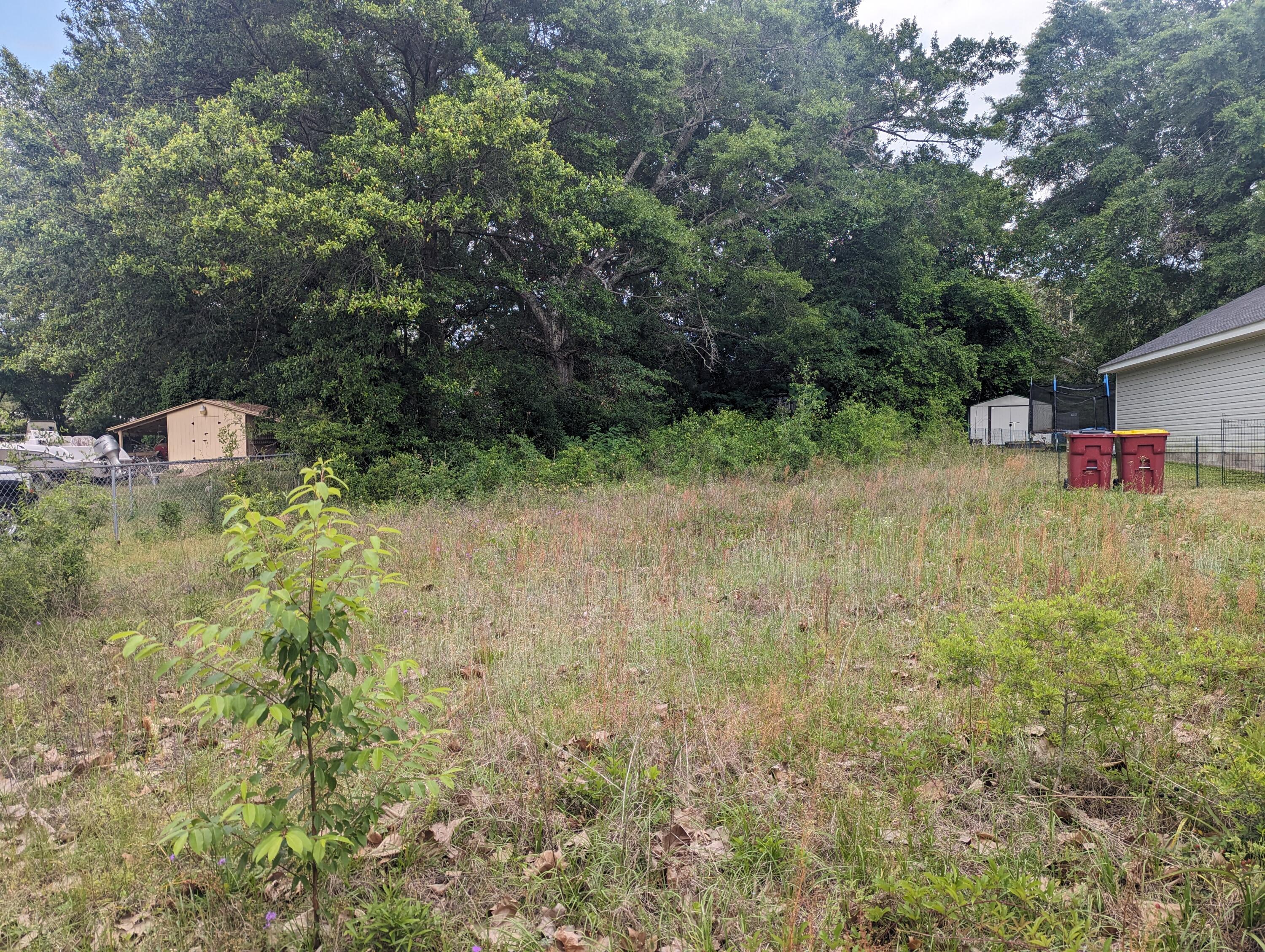 Vacant land for you to build your own home on a relatively flat lot.   Short travel times to Shopping, Restaurants, I-10, Military Bases, beaches ... Water, Septic and Electric available but tap fee has not been paid.