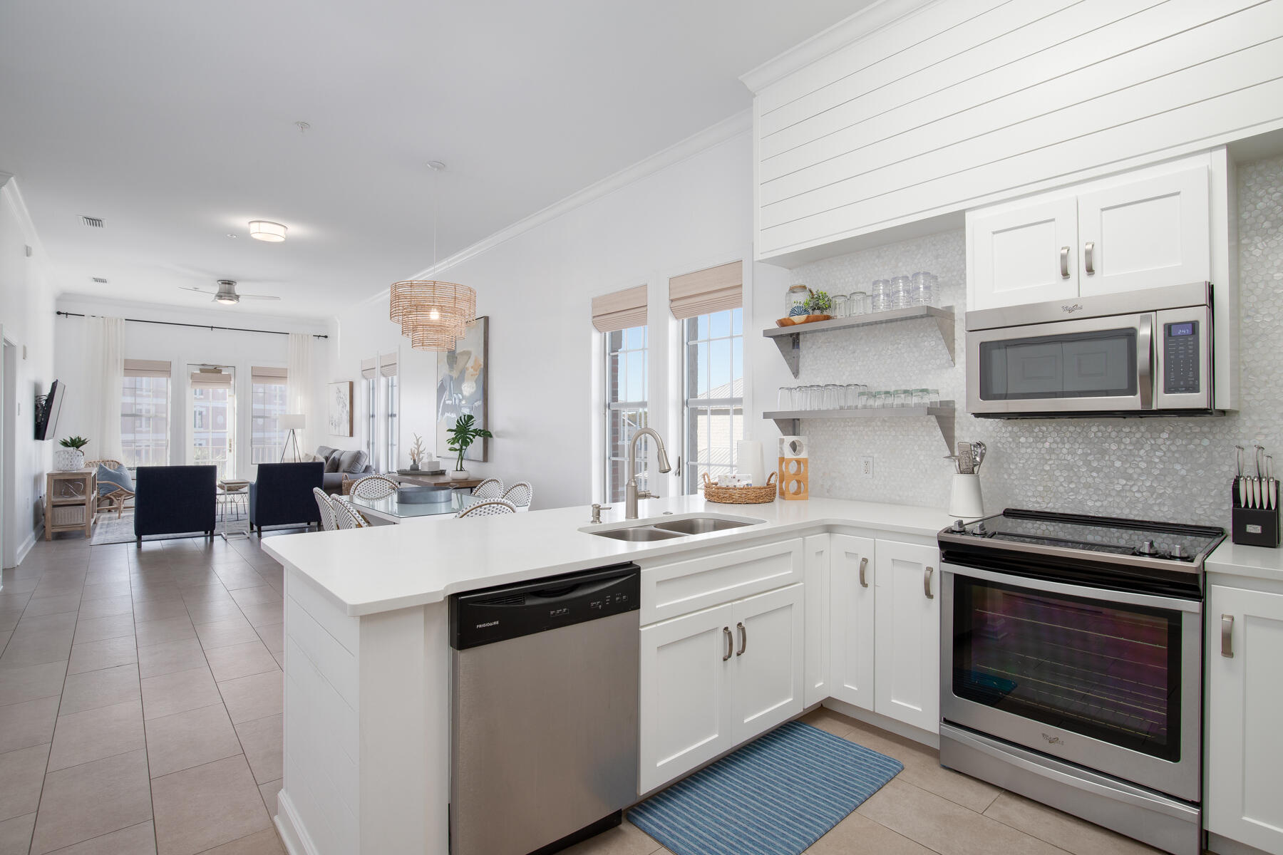 Live in luxury and enjoy all the best the 30A lifestyle has to offer with this 3BR/2BA stunning condo located in the heart of Inlet Beach. All within walking distance to the beautiful beaches, world class dining and shopping of Alys and Rosemary, but still tucked off the main highway enough to enjoy the peace and seclusion of the private Villages IV complex. This spacious corner unit is situated on the top floor of the building and features large windows allowing lots of natural light into the home. Enjoy the sunset on the balcony, or indulge in one of the two resort style pools within the community. The large open floor plan is one of the largest in the complex, and really maximizes the spaces for ultimate comfortability and practical living. Meaning there is plenty of space and storage for full time living or would equally work as a rental property.  The kitchen is adorned with stainless steel appliances and granite countertops. The master bathroom is oversized and has a separate shower and soaking tub.