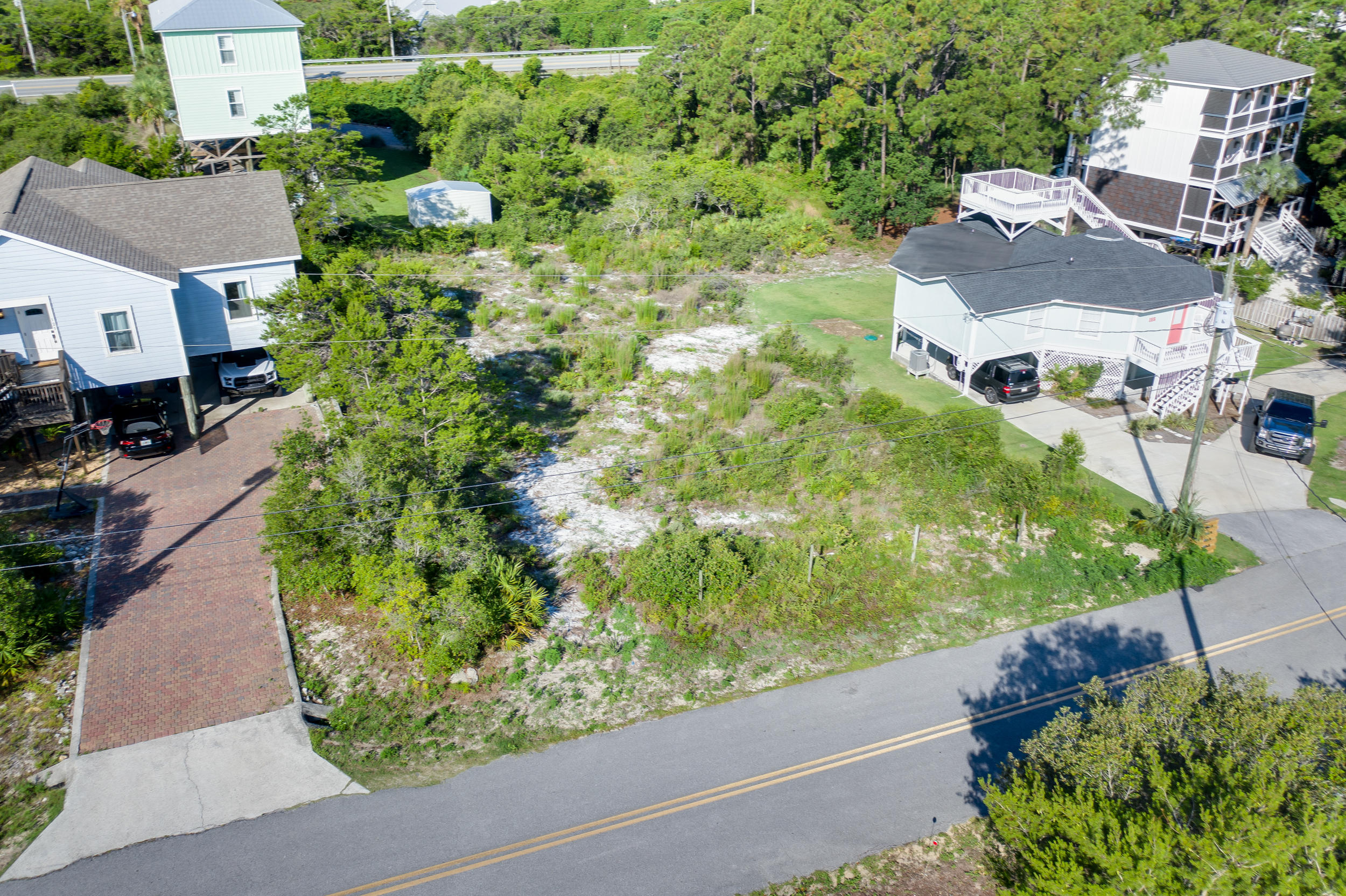Build your dream home on this amazing, nearly -1/4 acre lot and enjoy views of the Gulf of Mexico in many directions. The quiet and peaceful community of Beach Highland consists of all single family homes and, with NO HOA, you'll be able to choose from multiple building options. Brand New Beach Access with restrooms, wheelchair access and showers located just down the street. Perfect for the nature lovers, this homesite is nestled between Lake Allen and Stallworth Lake. Enjoy easy access to multiple trails and the Topsail Hill Preserve State Park to the West. For dining, a local seafood favorite, Stinky's Fish Camp is located less than -1/2 a mile away or venture out further West on 30A to Miramar Beach that offers additional Dining, Shopping and Entertainment options.
